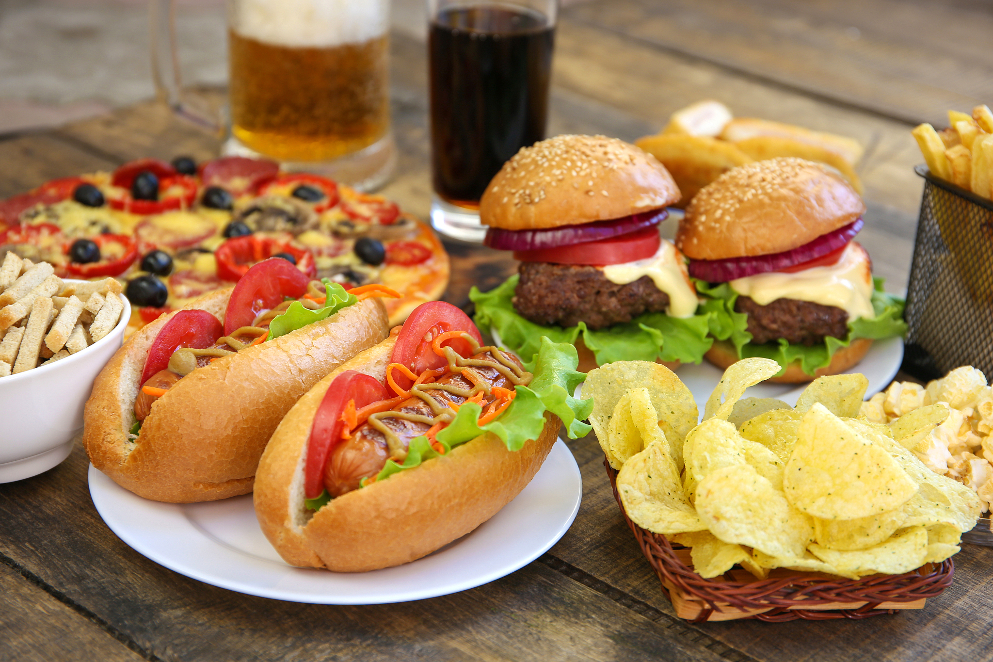 fast food on old wooden background. concept of junk eating.