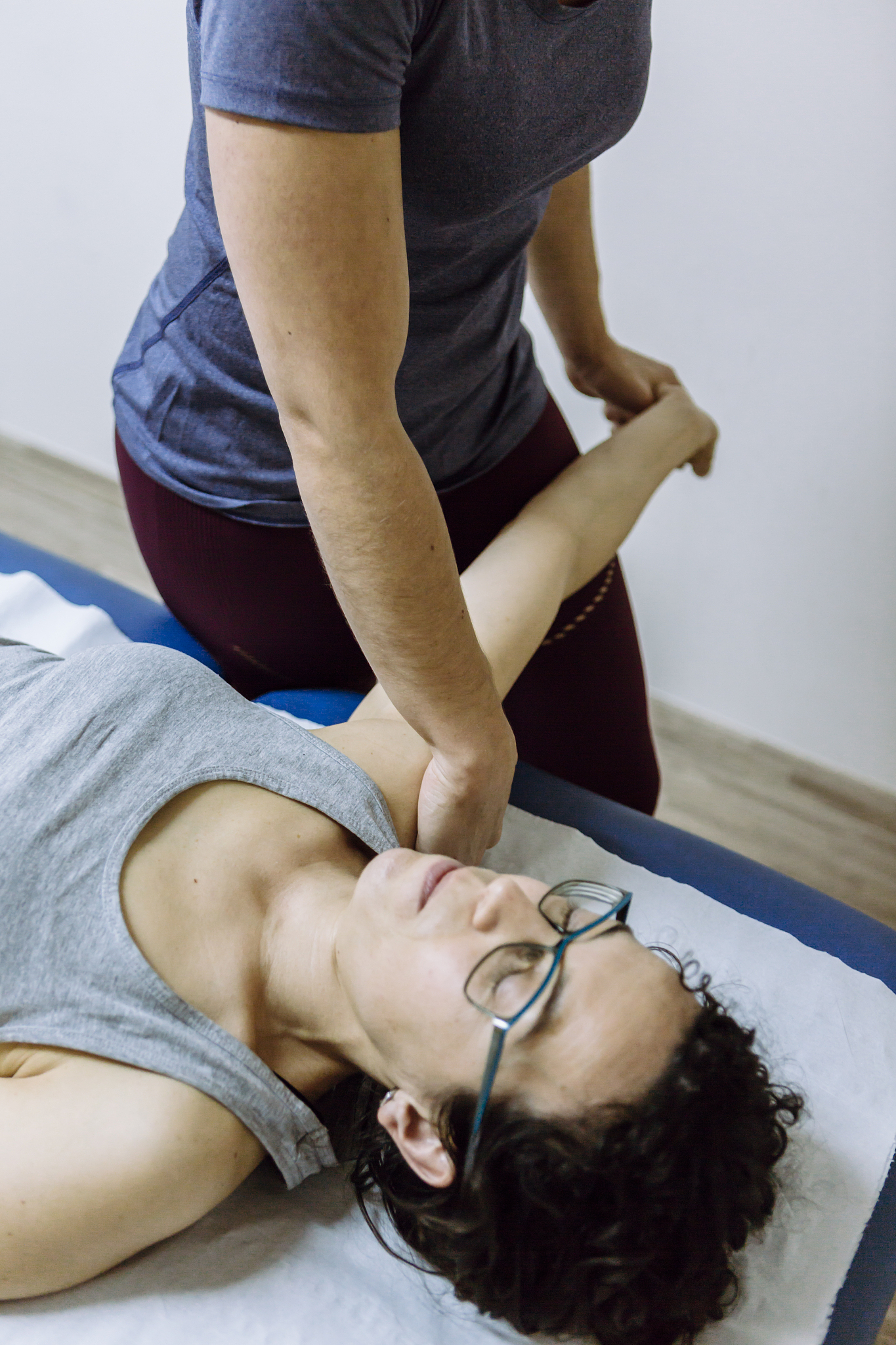 female physiotherapist stretching leg of client
