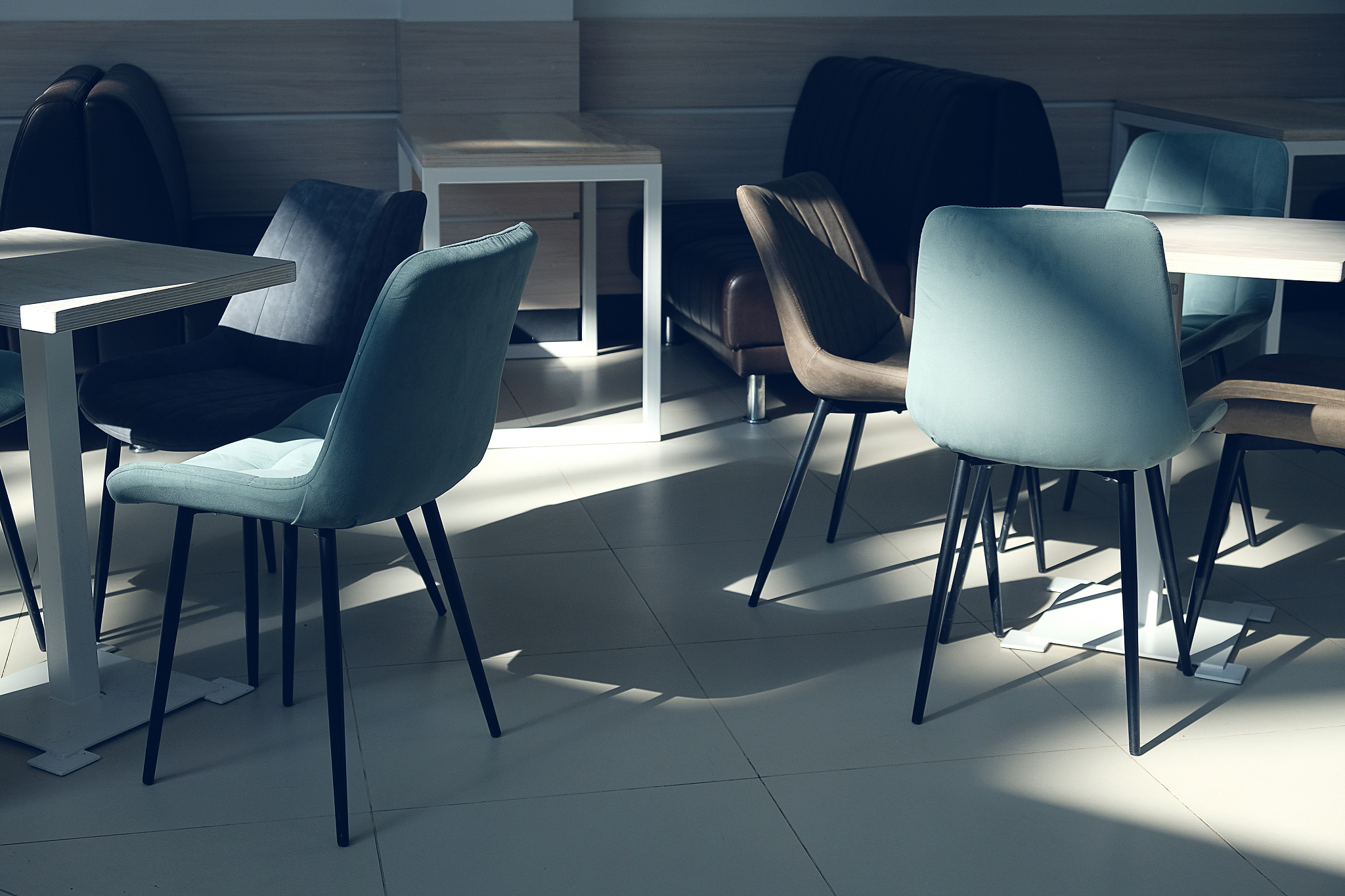 an empty room of a cafe, office with wooden tables and velour ar
