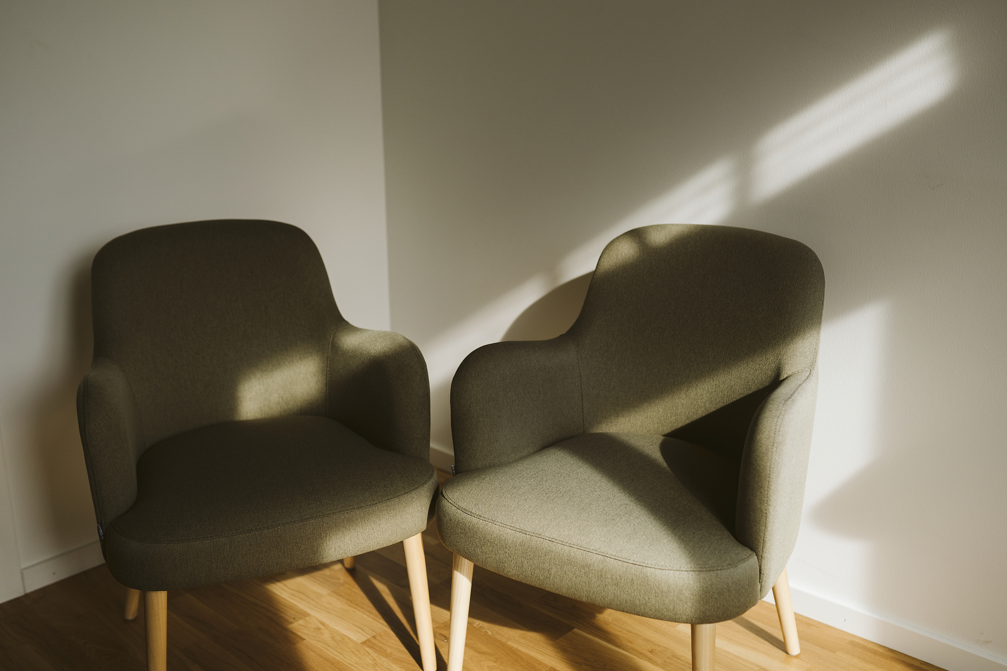 two armchairs in corner of room