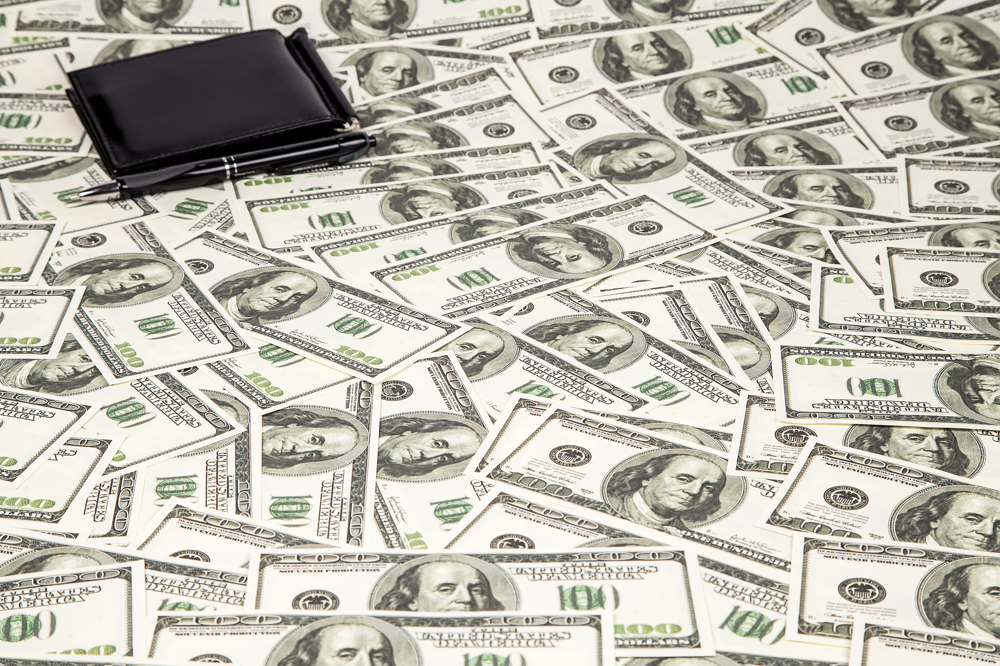 background a lot of hundreds dollars and wallet