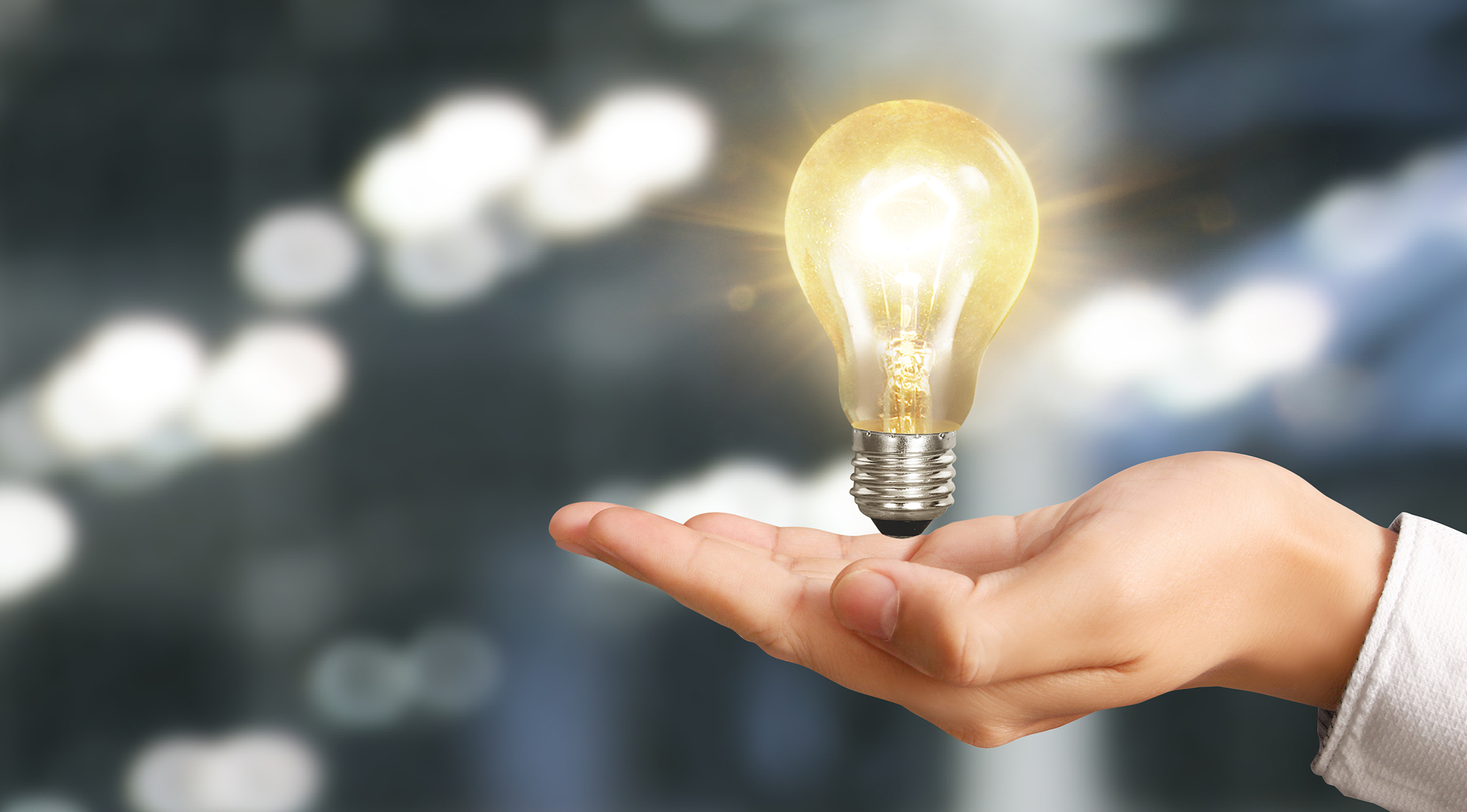 hand of holding illuminated light bulb. innovation inspiration c