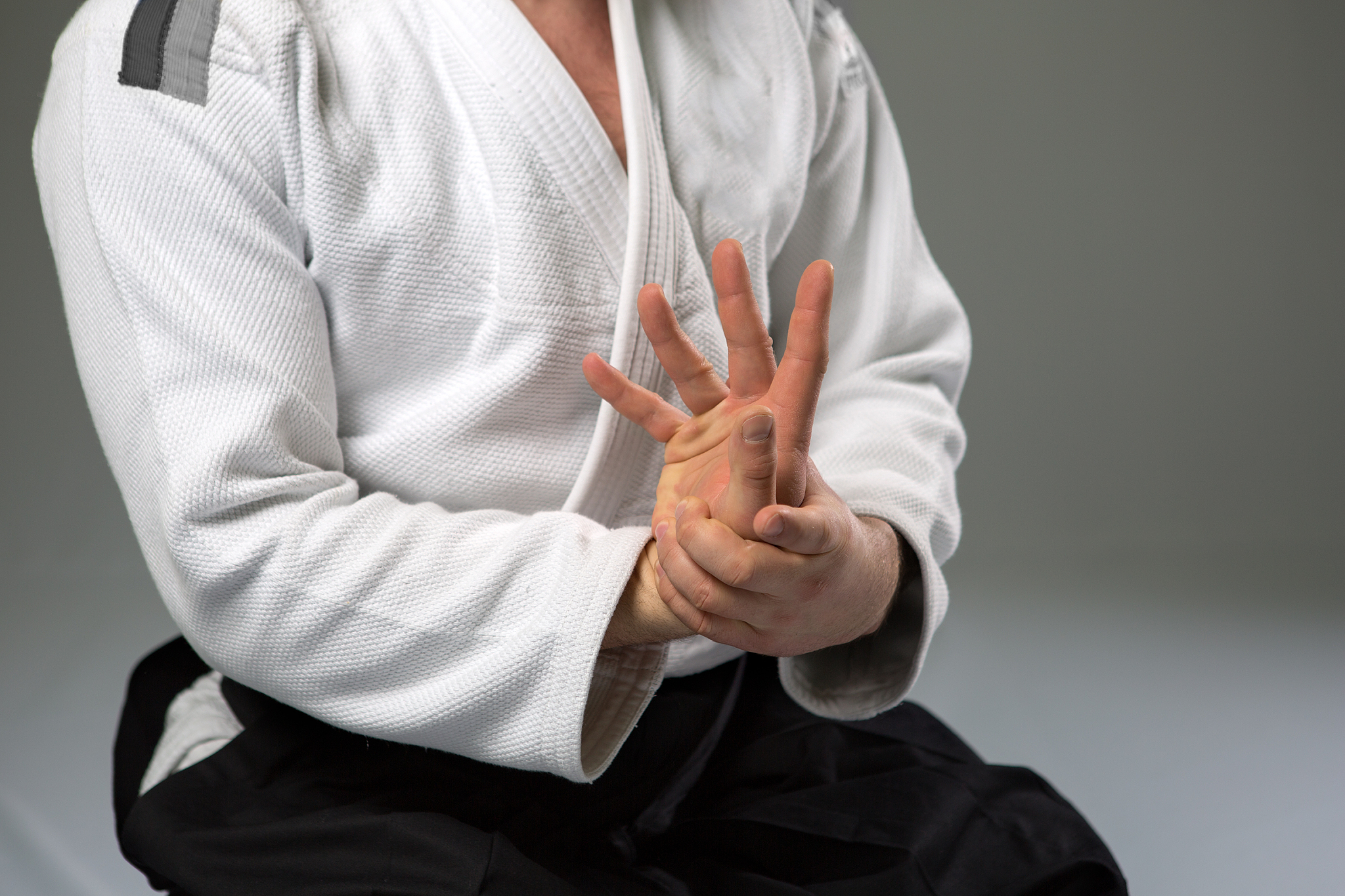 two caucasian men are practicing aikido on the tatami