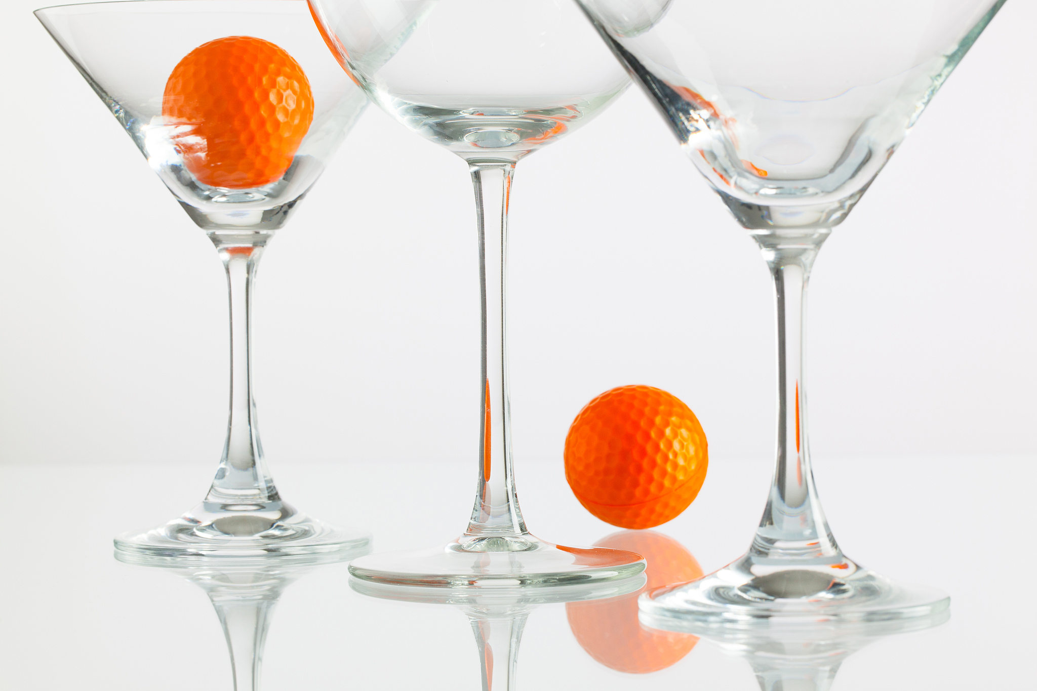three glasses of champagne and golf equipments
