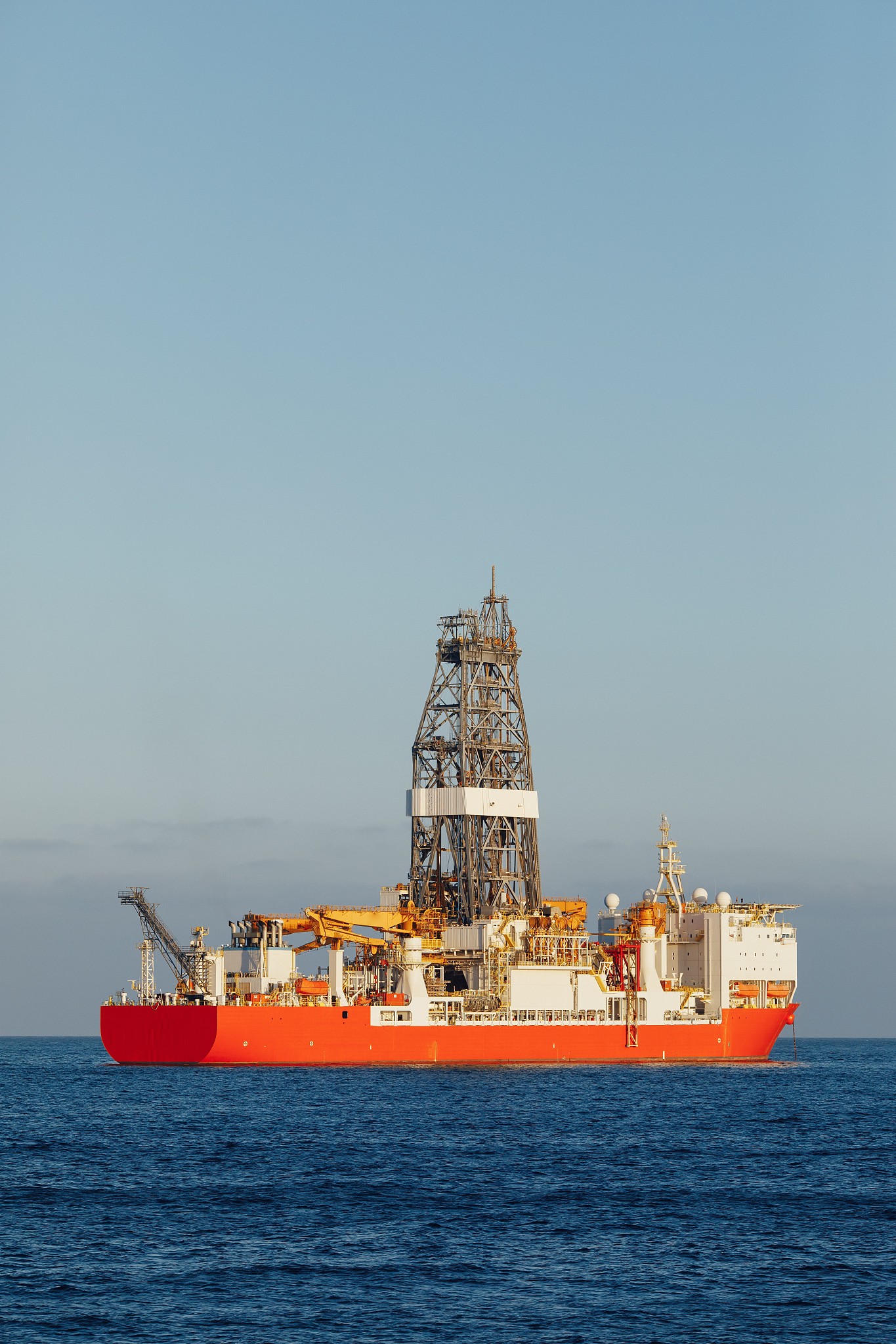 offshore oil and gas drillship, blue ocean background
