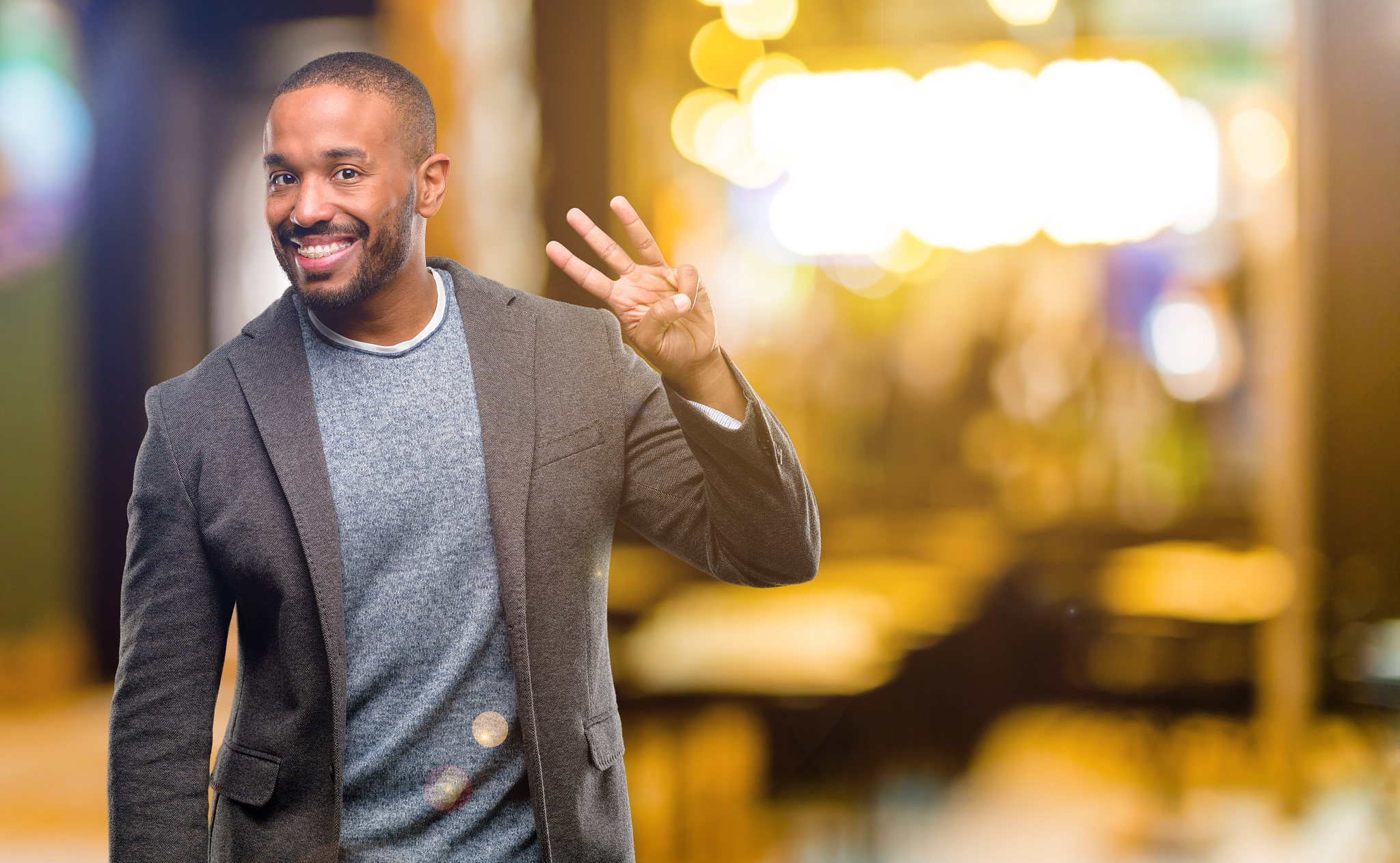 african american man with beard raising finger, is the number th