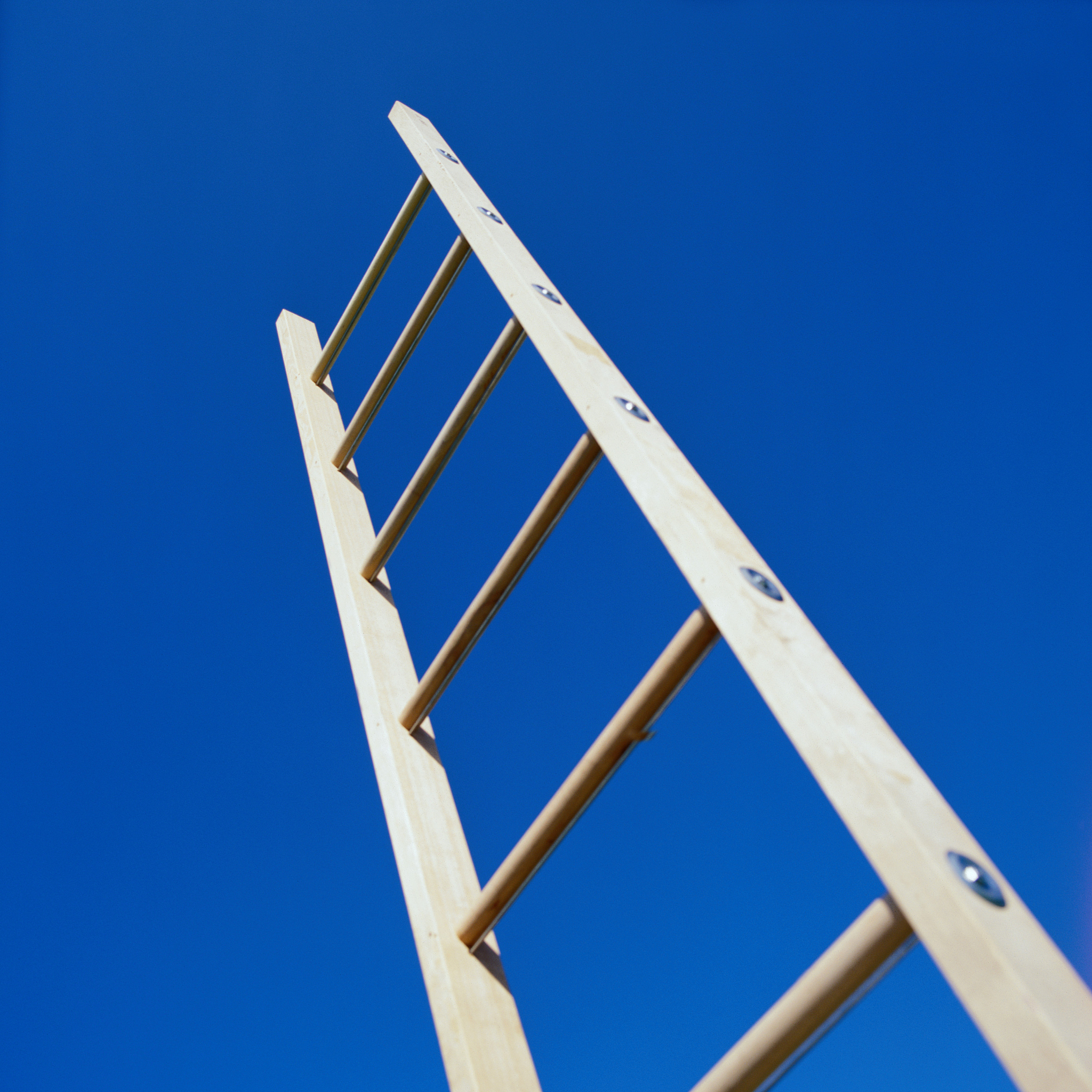 wooden ladder rising into the sky