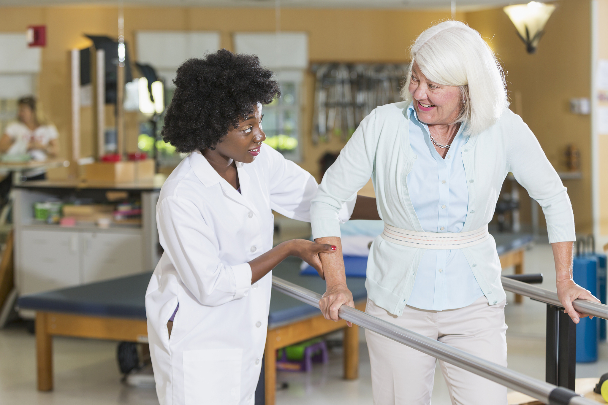 physical therapist working with female patient