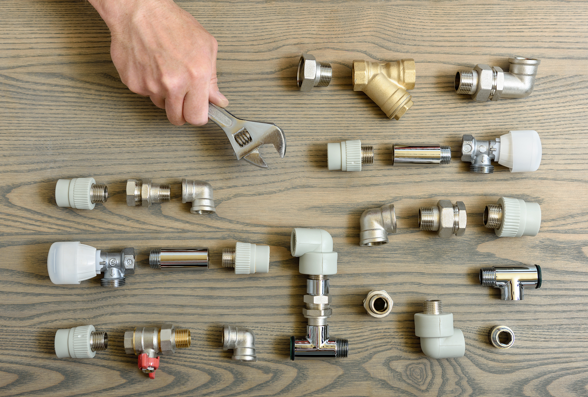 a human hand is holding the adjustable wrenches.