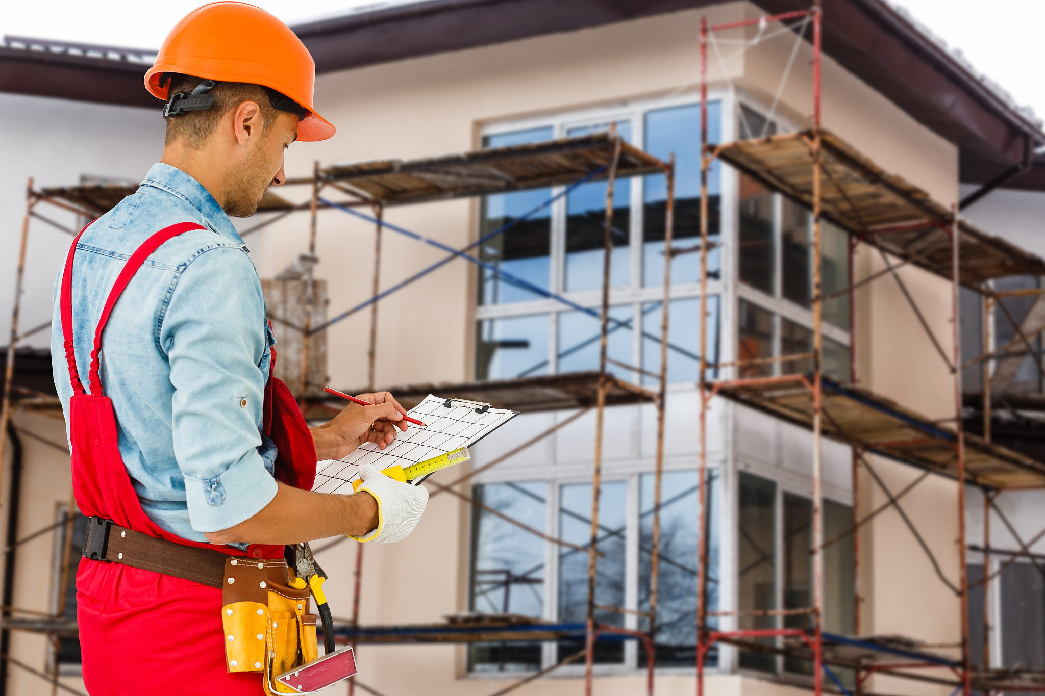 builder handyman with construction tools. house renovation backg