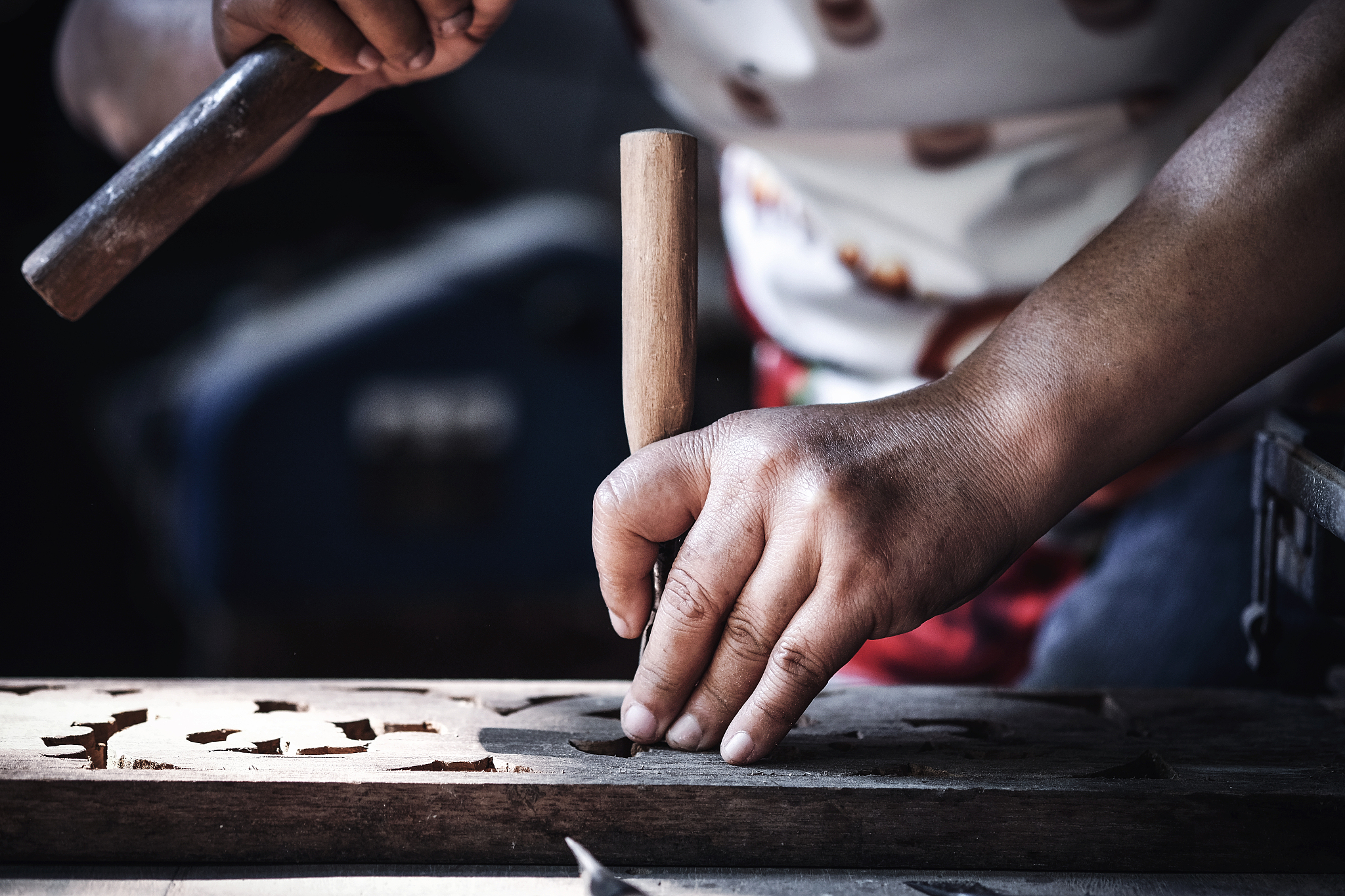 hand of women with wood carving tools to create handcraft art.