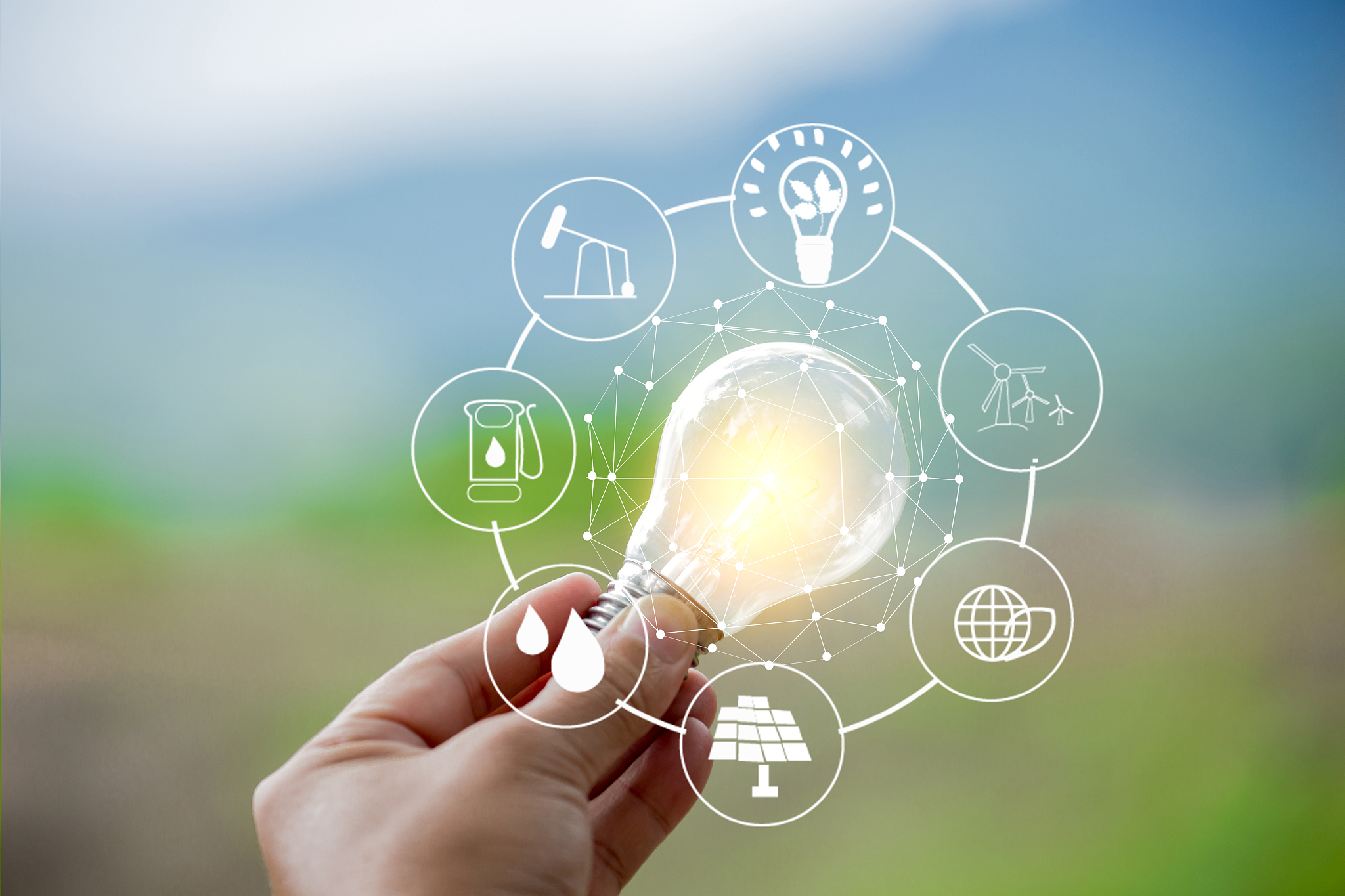 digital composite image of person holding illuminated light bulb