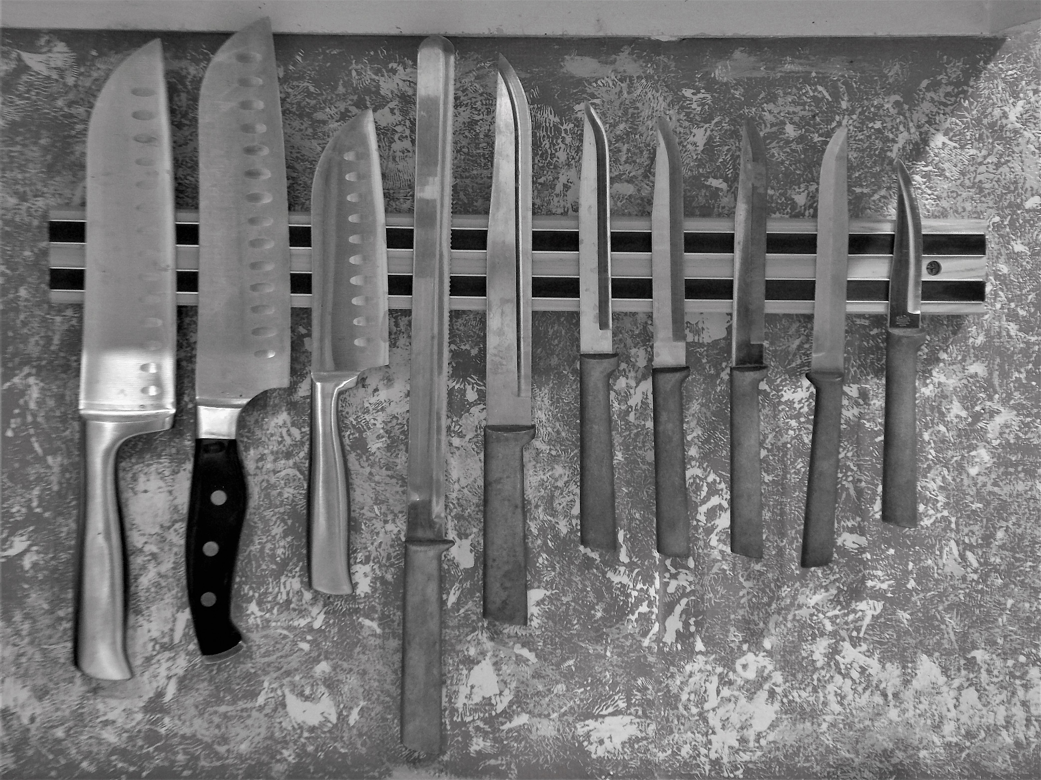 royalty free photograph - magnetic knife bar on the kitchen wall