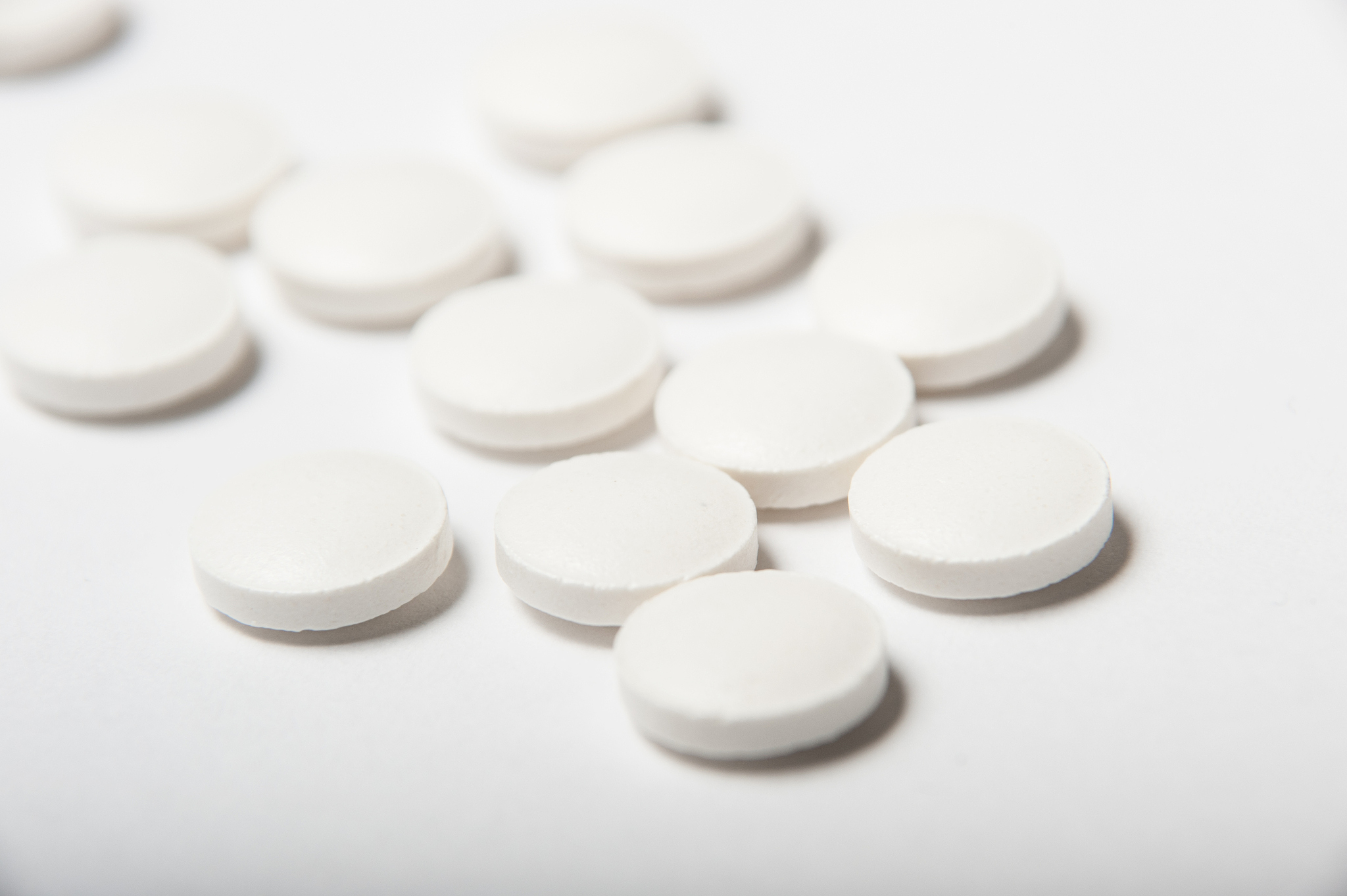 white pills on a white background