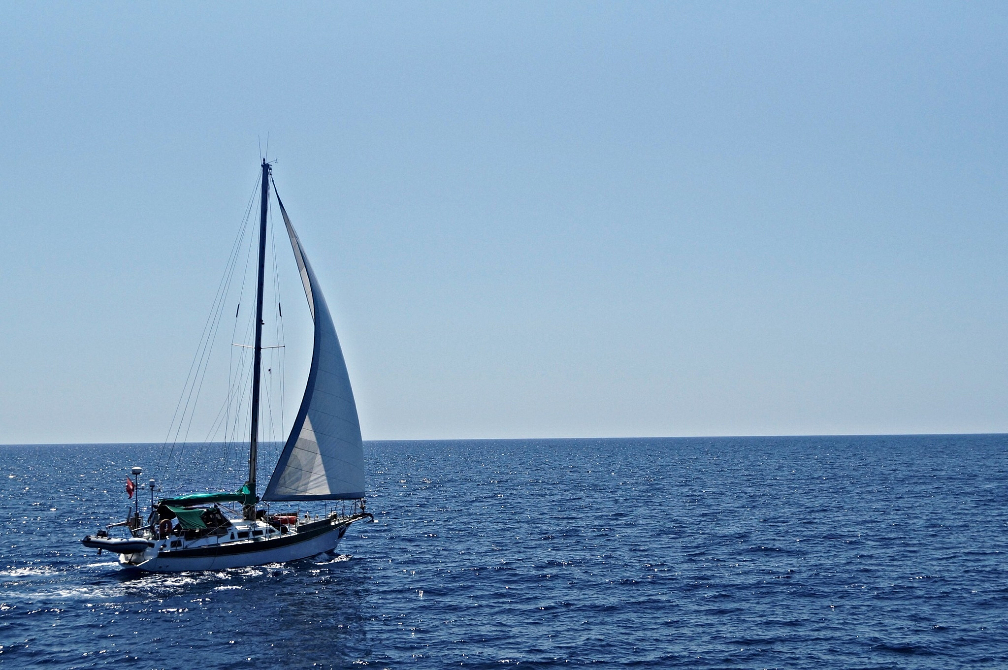 lone boat in calm sea against clear sky