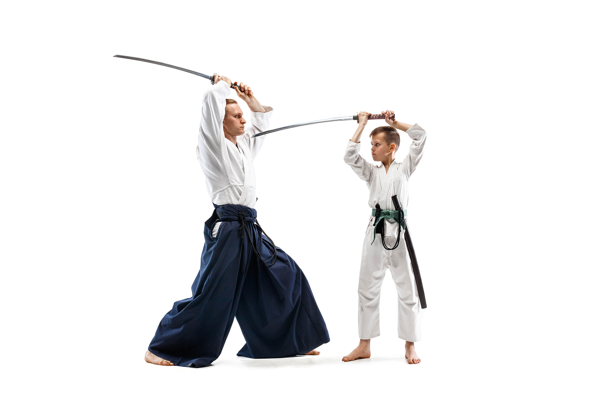 man and teen boy fighting at aikido training in martial arts sch