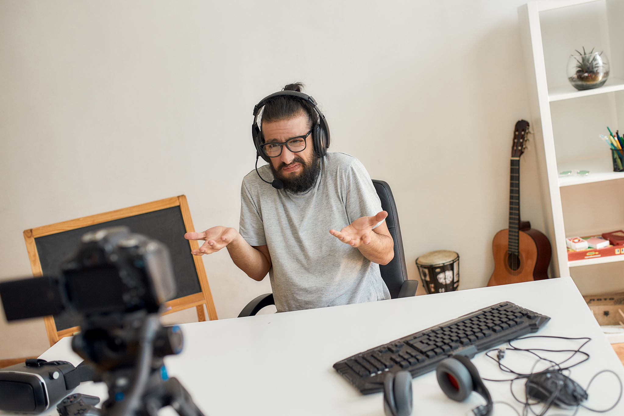 male technology blogger wearing headphones, looking dissatisfied