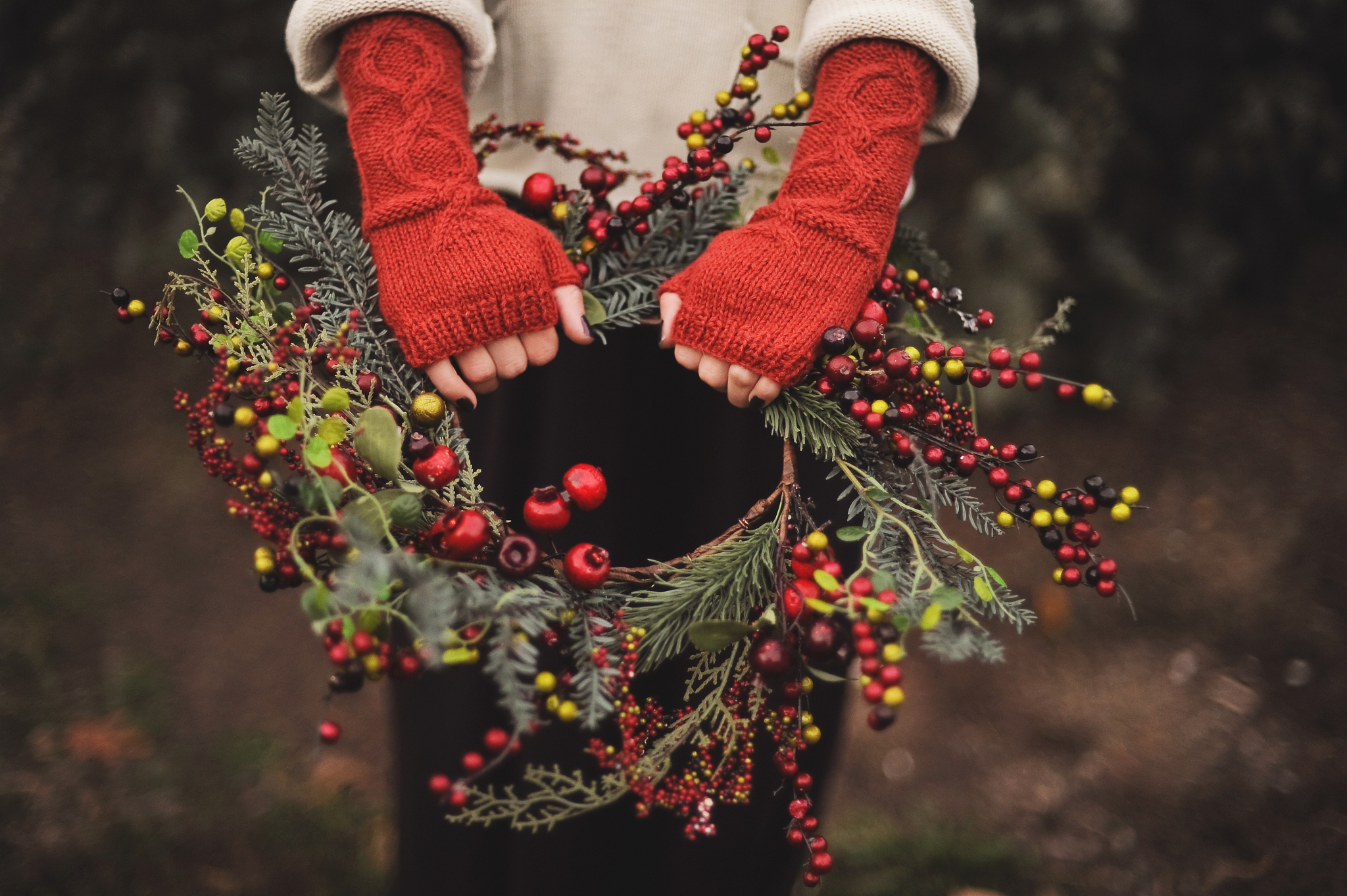 wreath held by woman wearing orange arm warmers