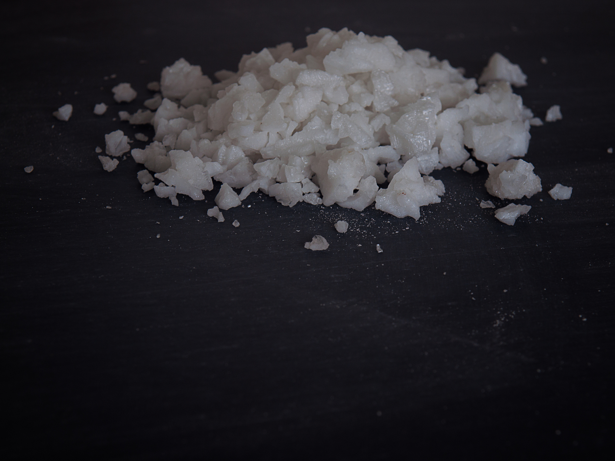 white salt on black background.