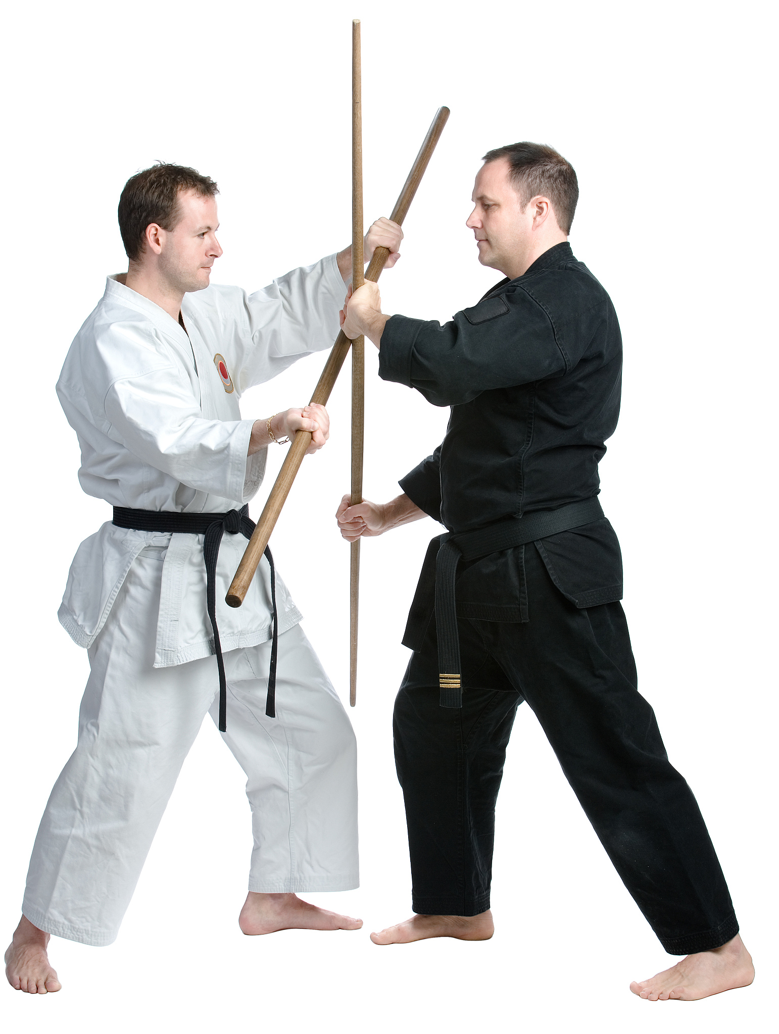 two men in martial arts combat with staffs