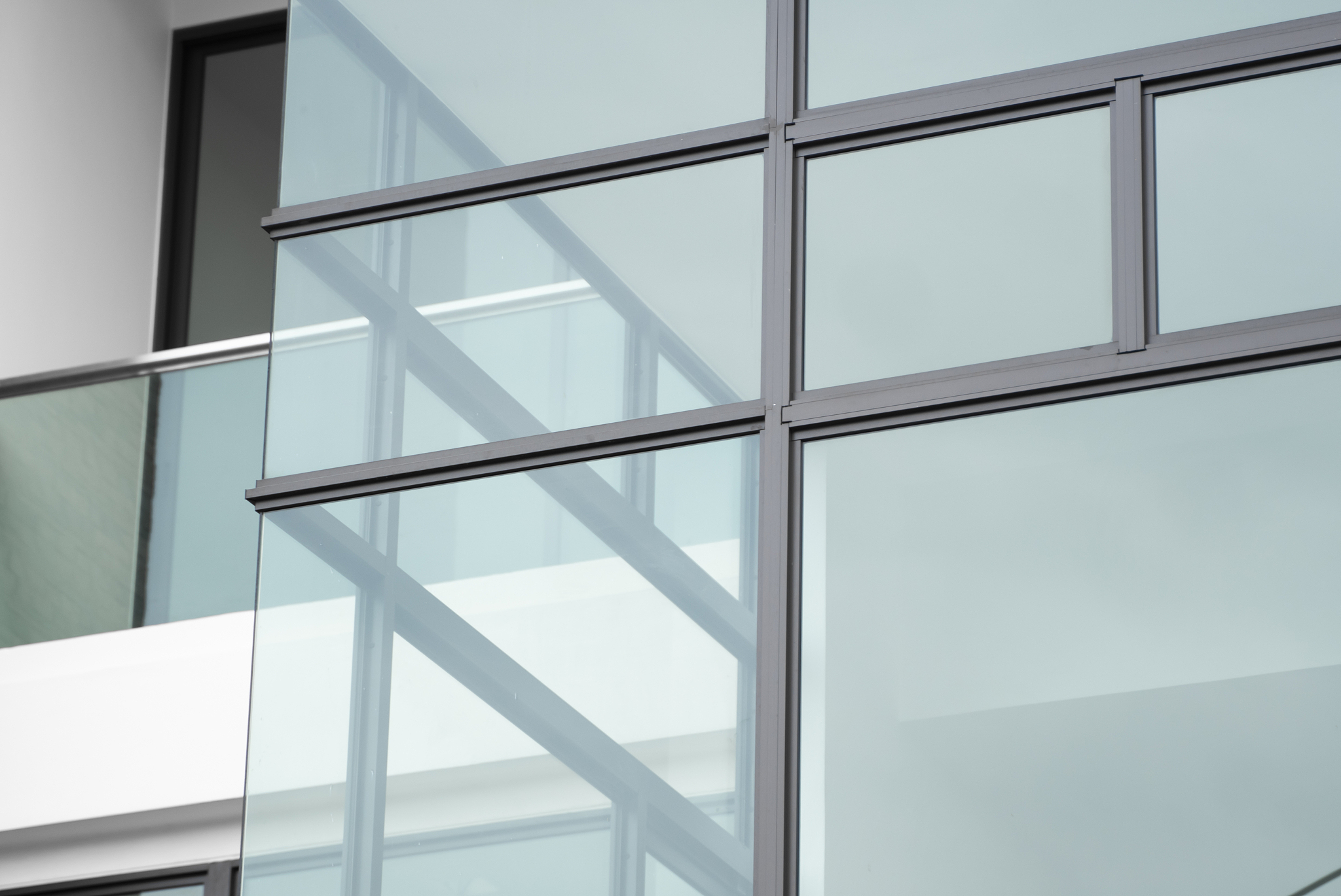 windows of modern apartment buildings exteriors in cloudy day.