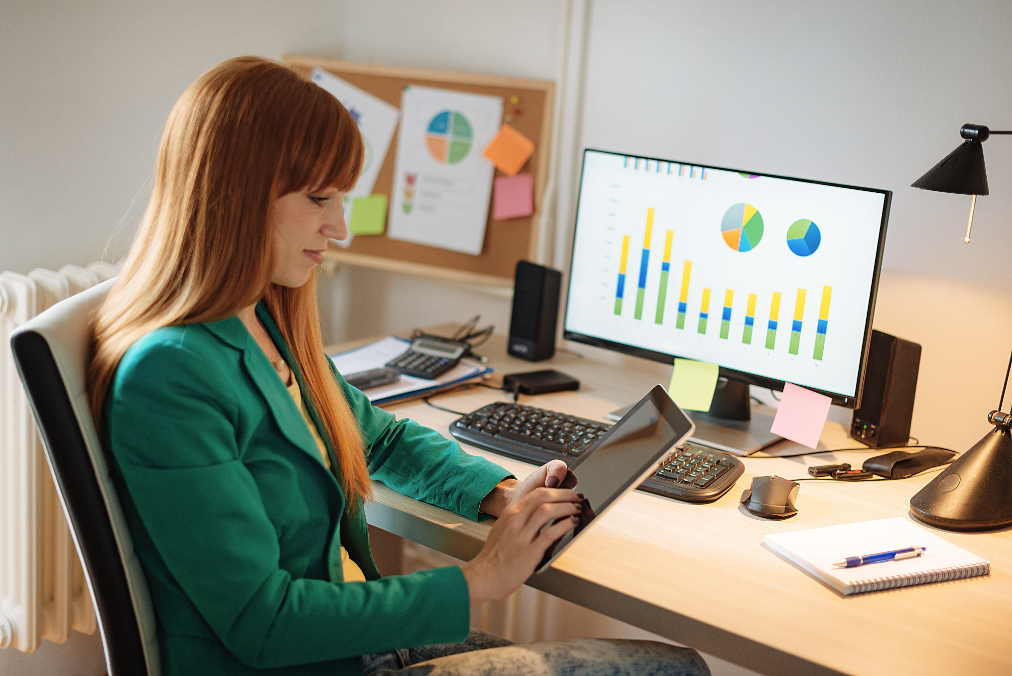 woman working on digital tablet and computer at home
