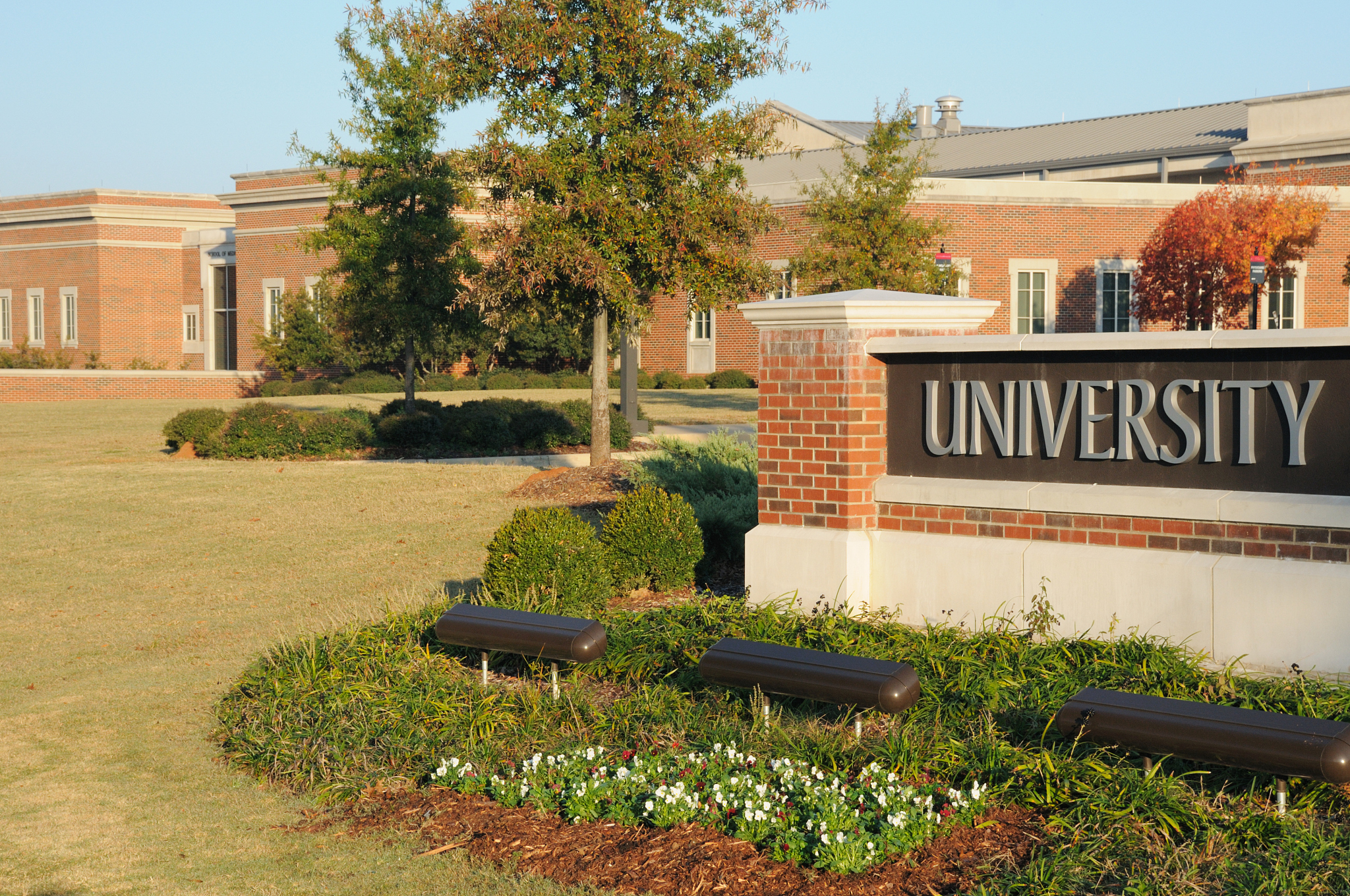 university sign with building