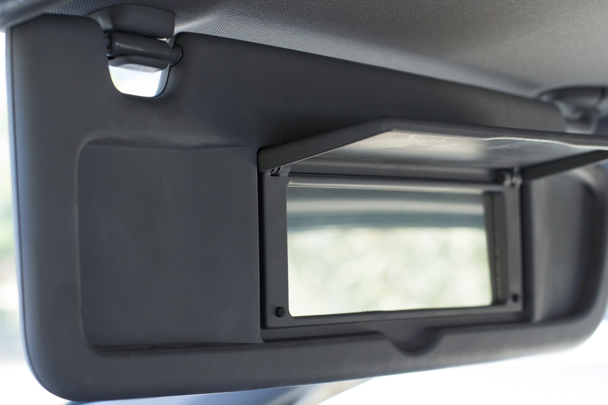 vehicle visor down with passenger mirror open