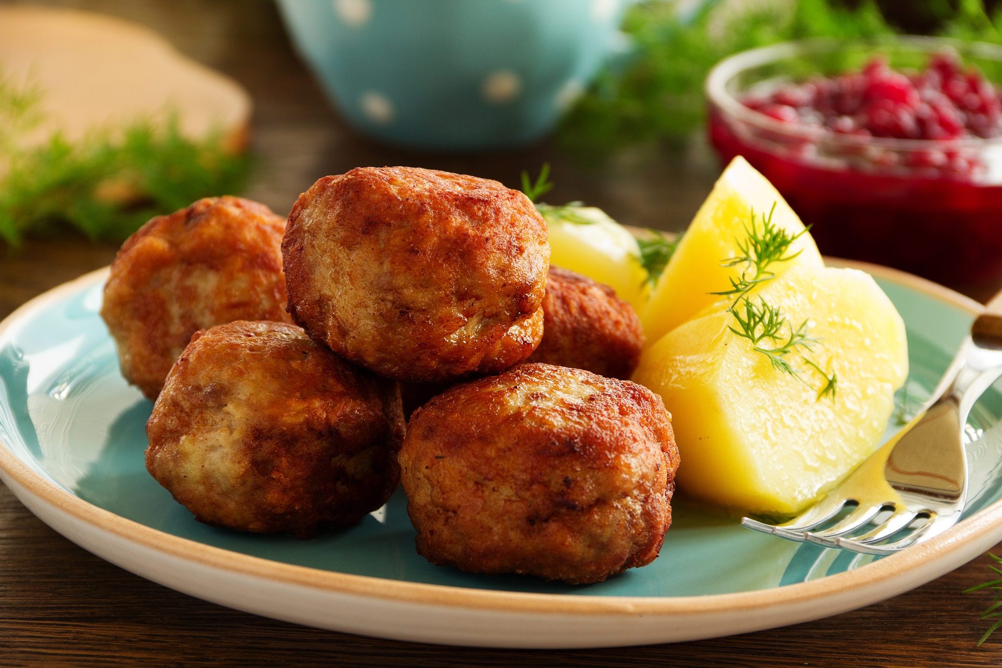 hot meatballs with boiled potatoes and cranberry sauce ..