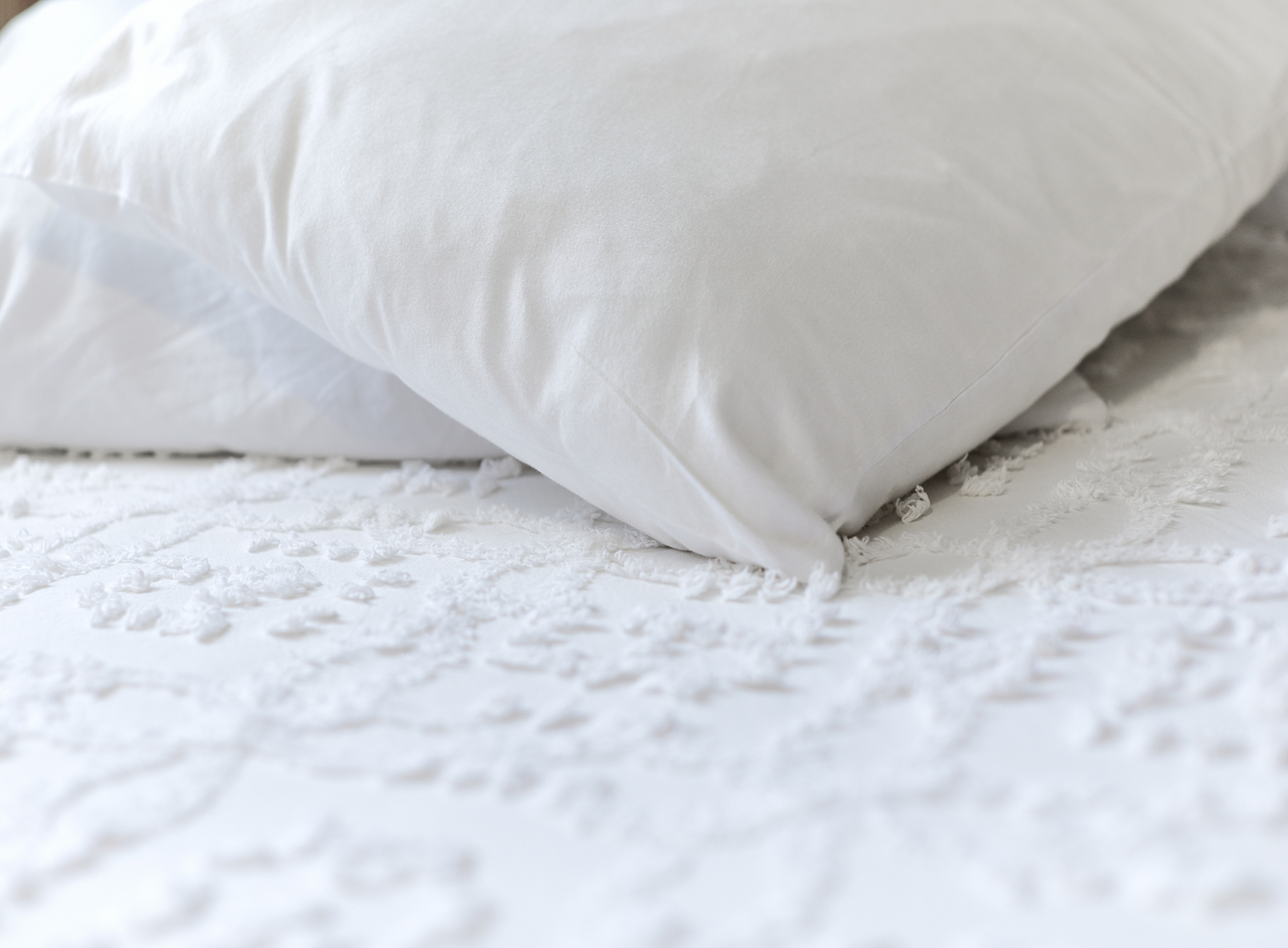 white pillows and bedspread