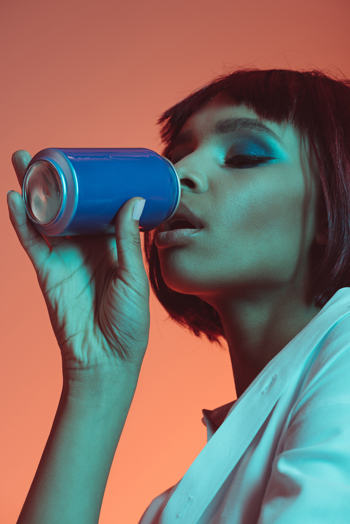 sensual african american girl drinking beverage from can with ey