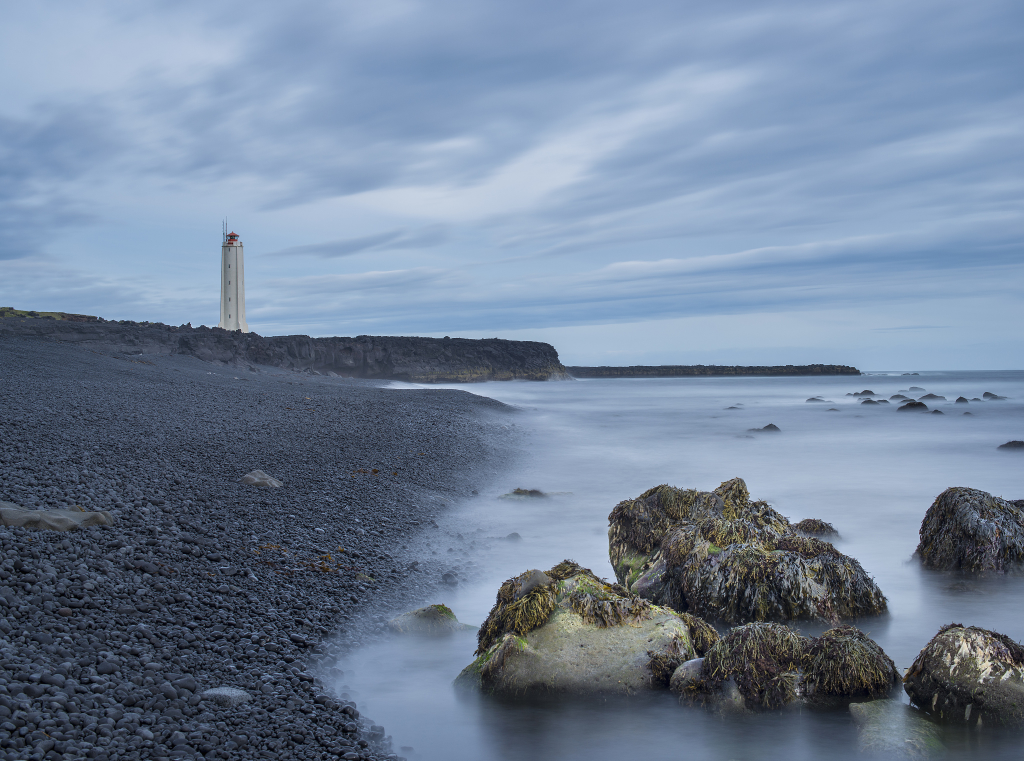view of rocks, seaweed and lighthouse, malarif, snaefellsnes, ic