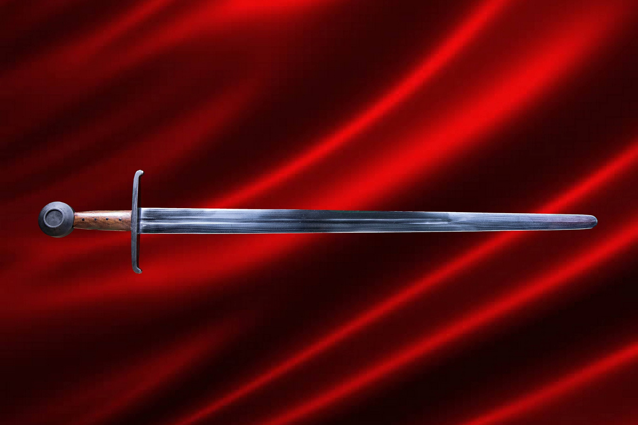 medieval sword against red satin background.