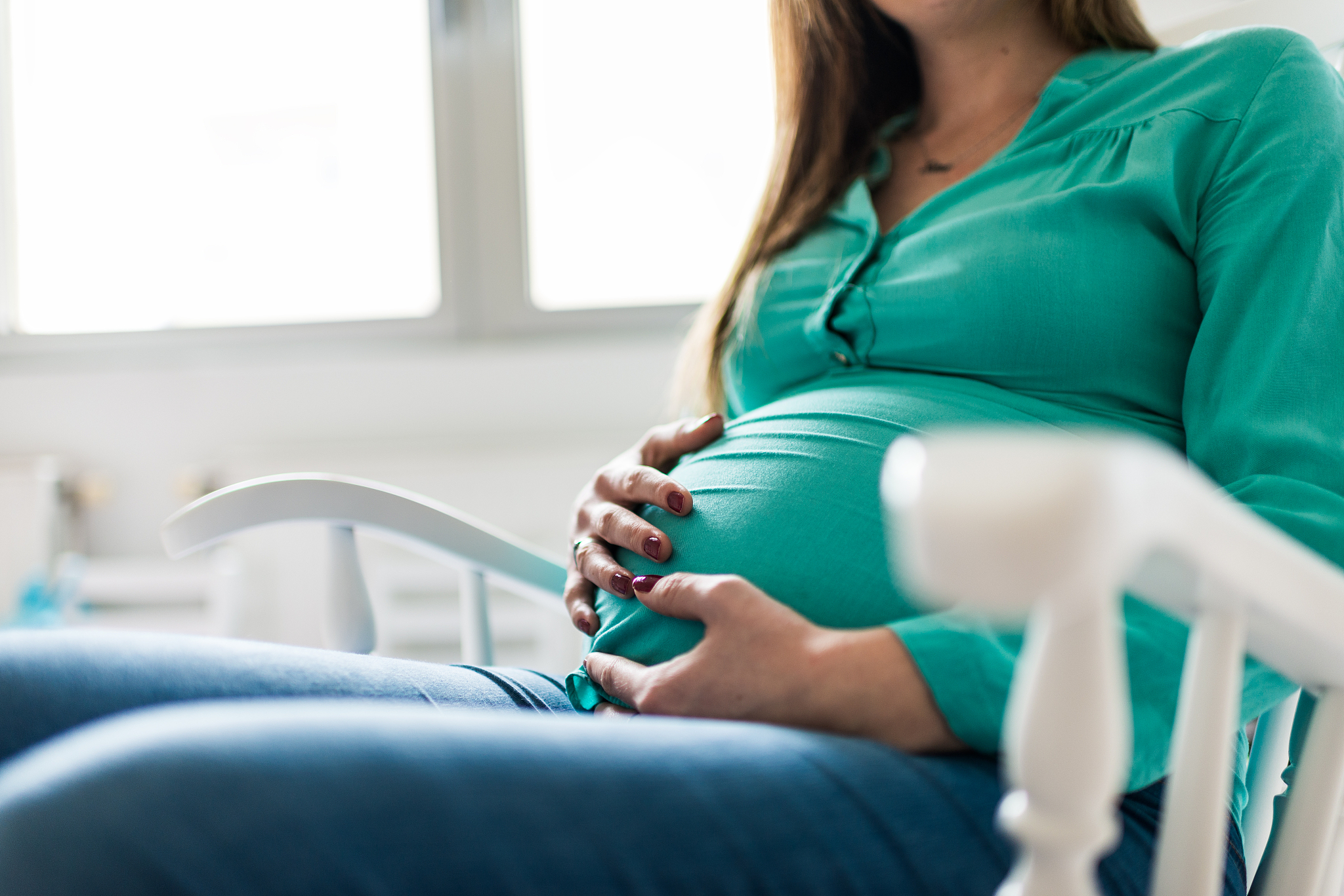 beautiful pregnant woman in a rocking chair