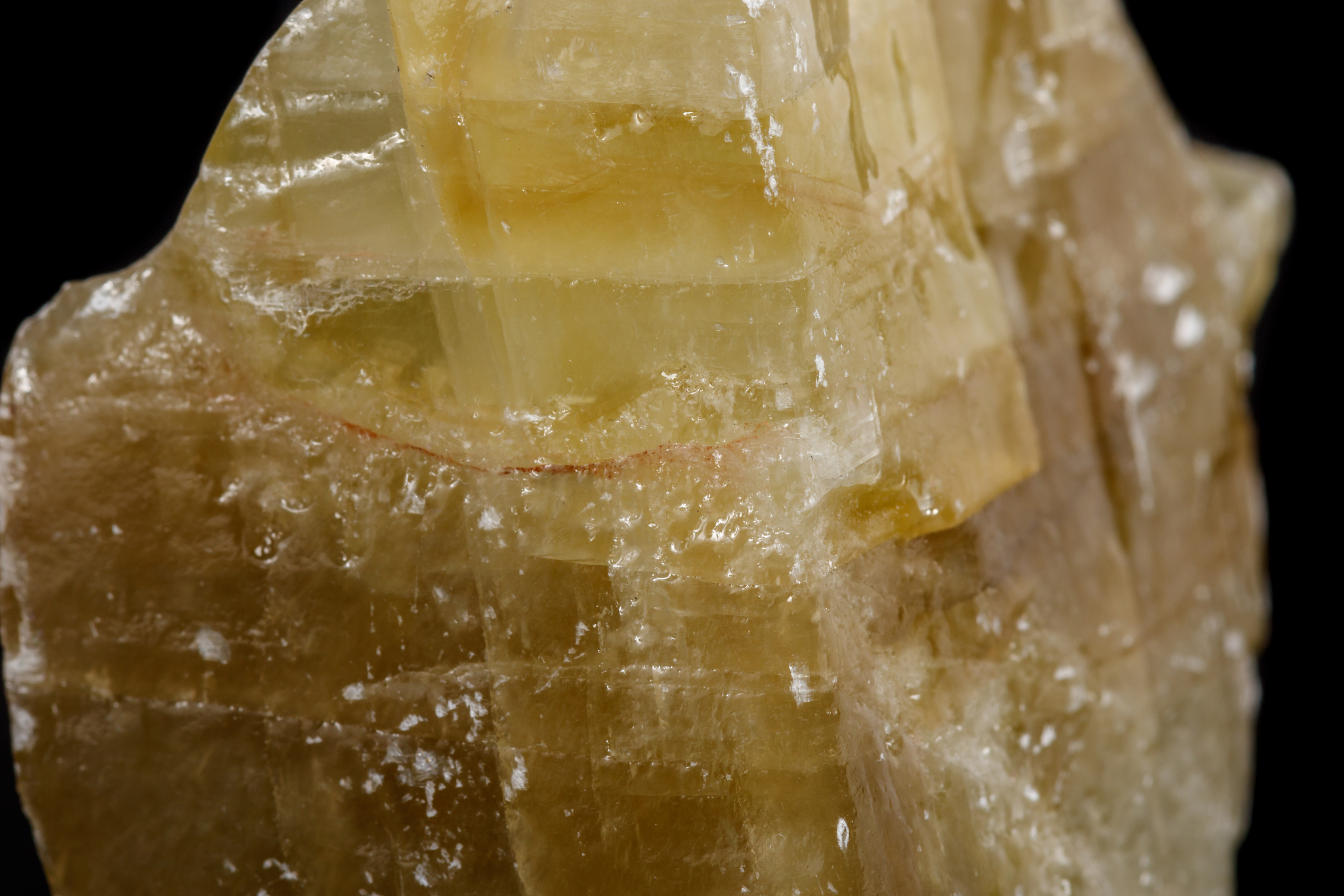 macro mineral stone yellow calcite on a black background