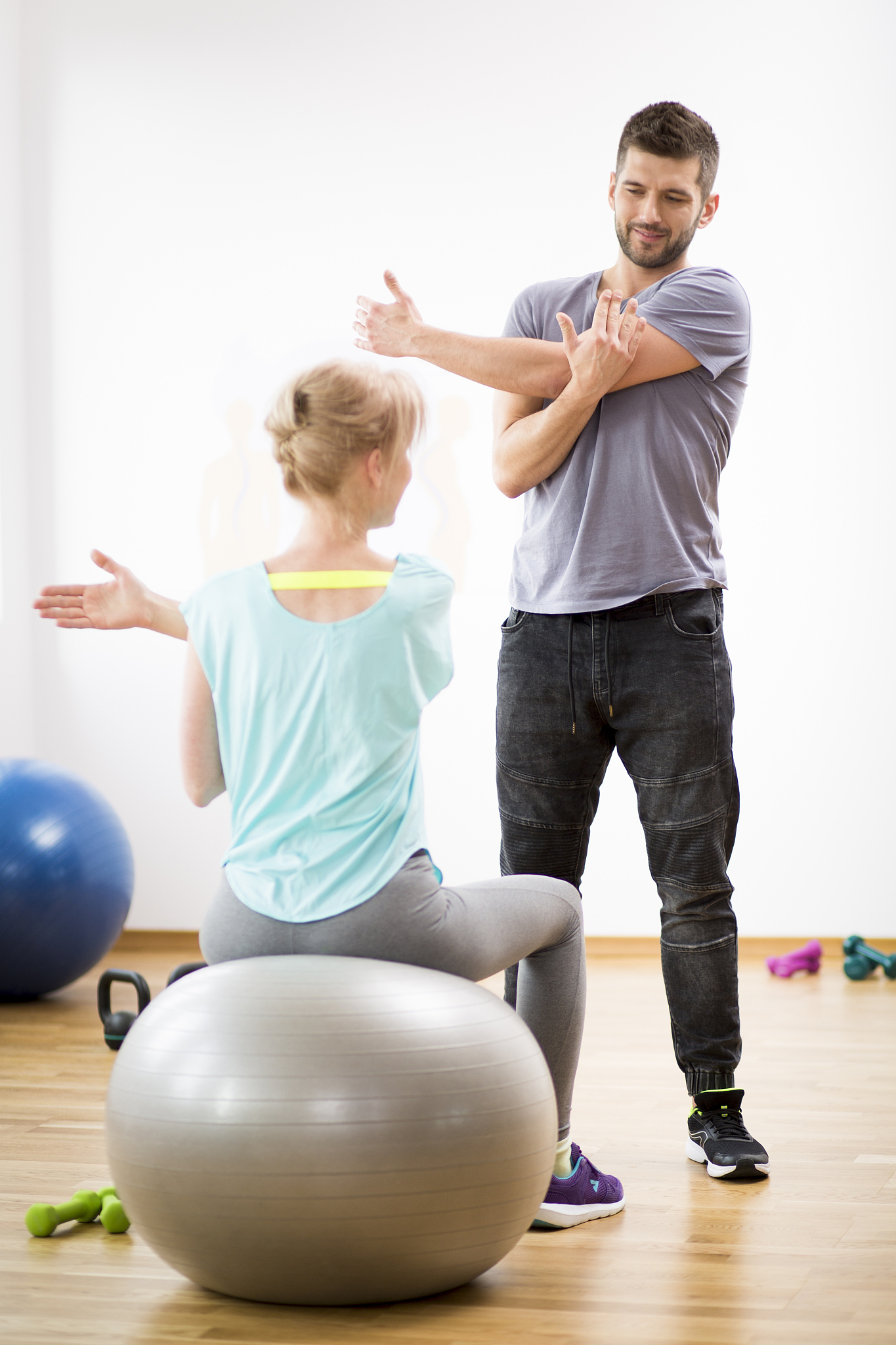 middle age blond woman exercising on gymnastic ball during sessi
