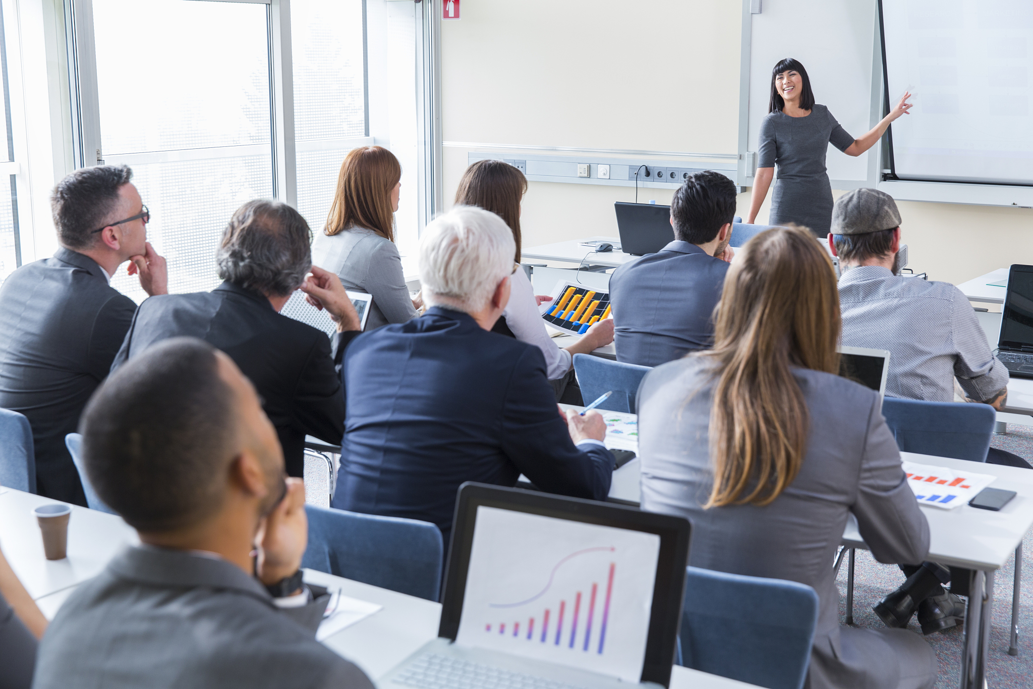 business people in a classroom listening lecturer
