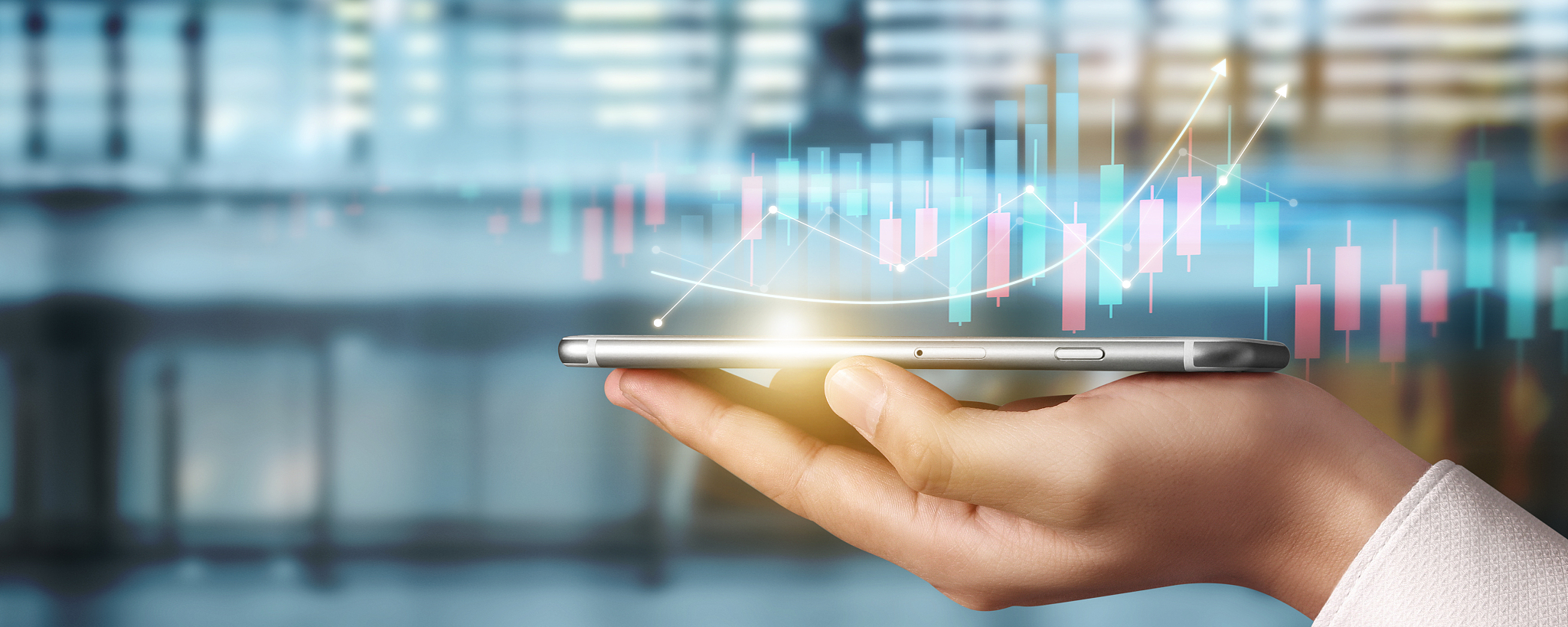 smartphone in hand plan graph growth and increase of chart posit