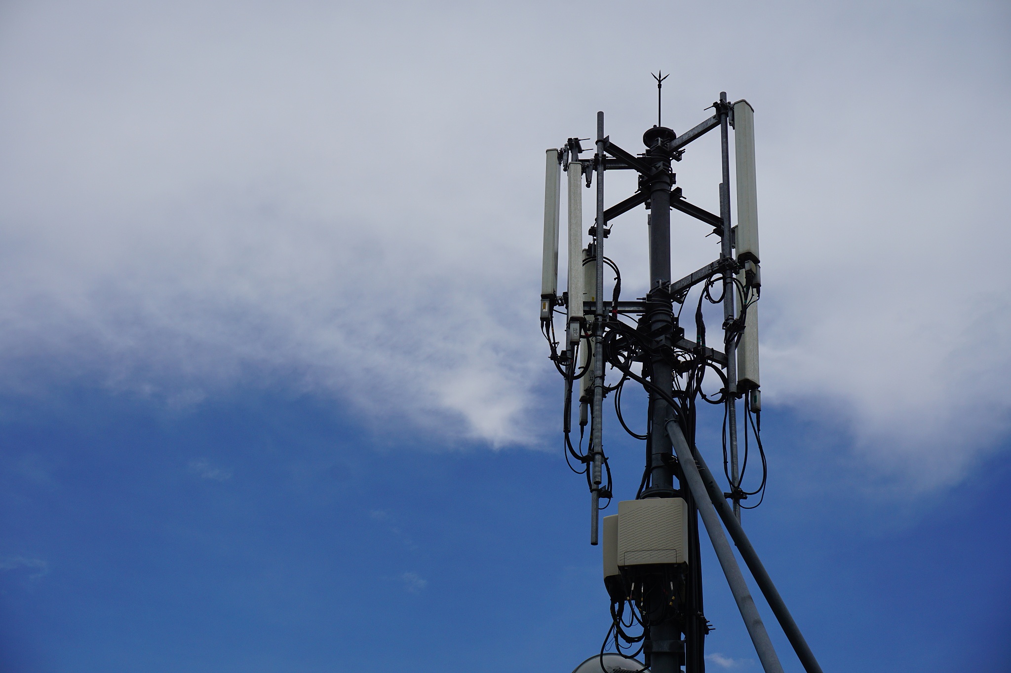 cell phone telecommunication tower with clouds,blue sky