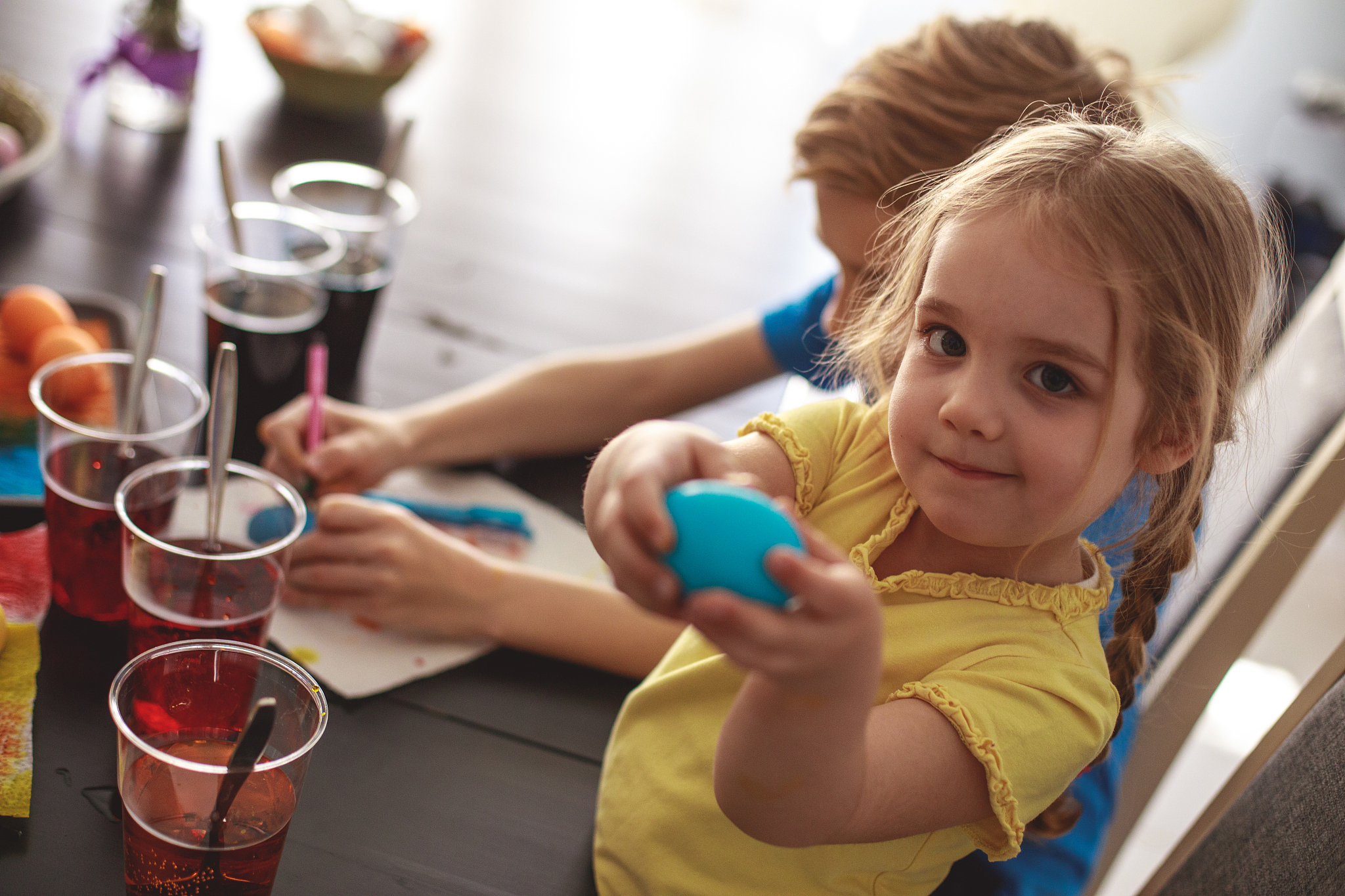 little girl showing off an easter egg she dyed