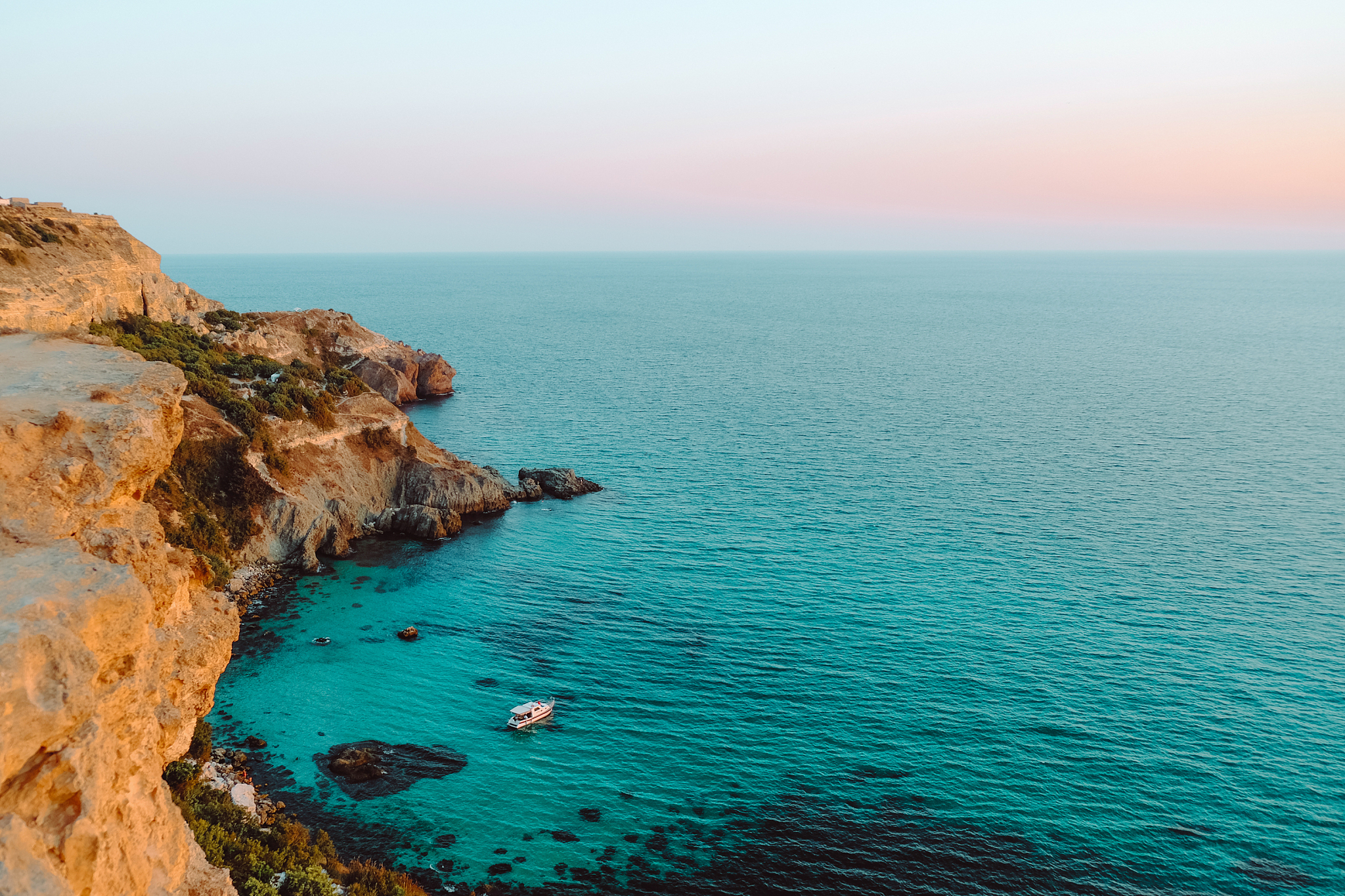beautiful azure sea and rocky cliffs at sunset.