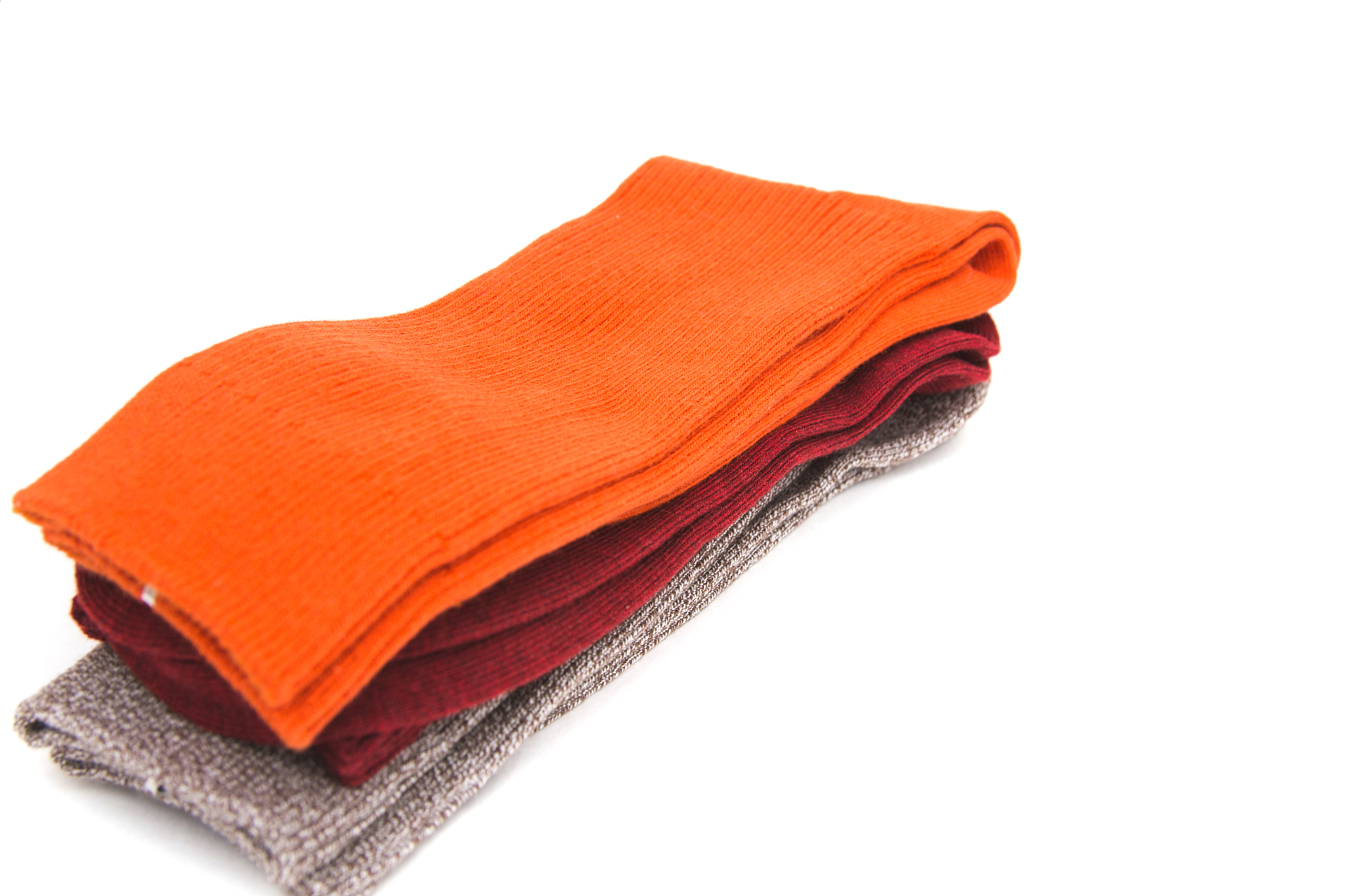 pack of stylish colorful multicolored man socks, lying on white 