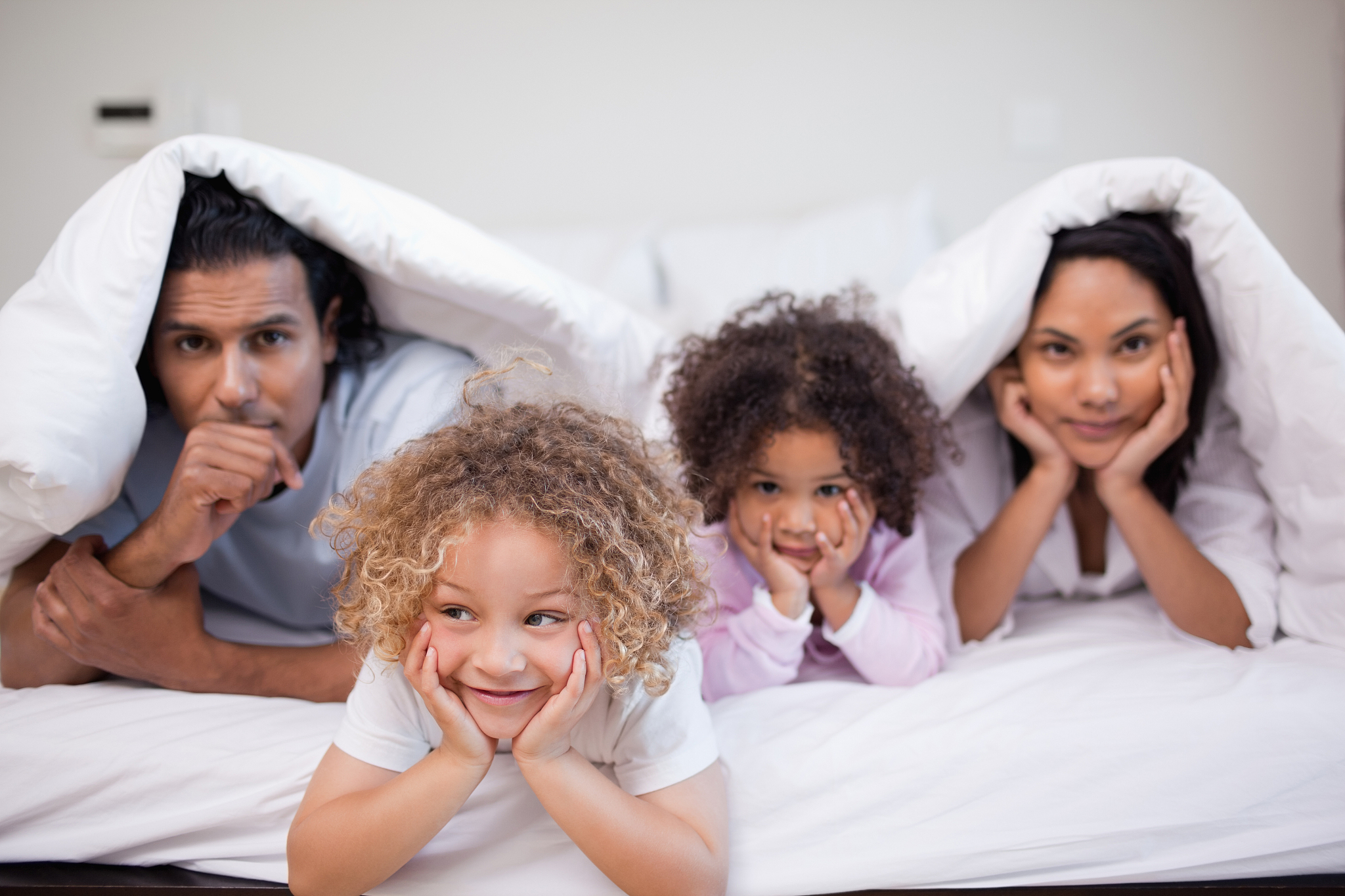 young family playing in the bedroom