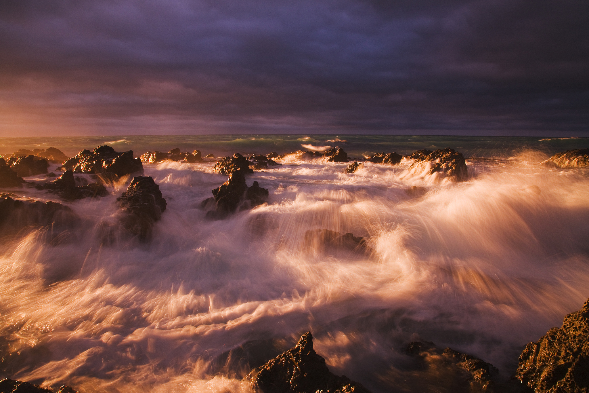 waves on rocky coastline at sunrise
