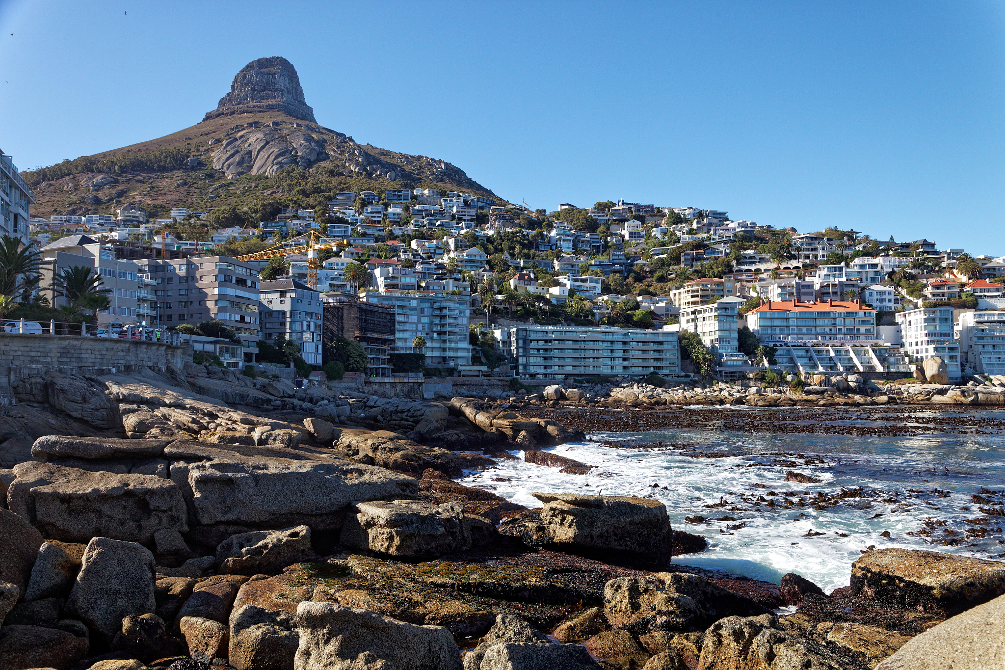 the coastal suburb of sea point and rocky bay with the lions hea