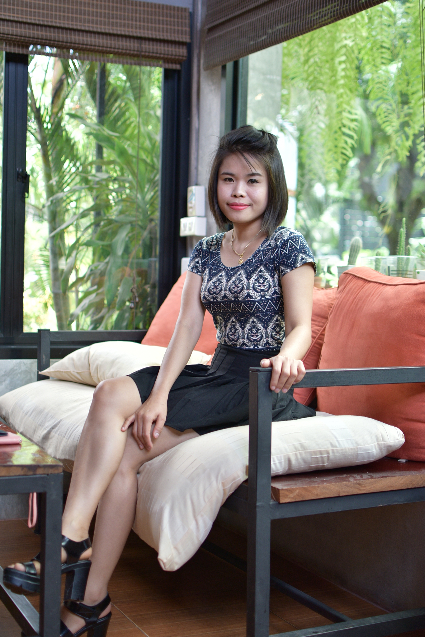 portrait of woman sitting on seat at cafe