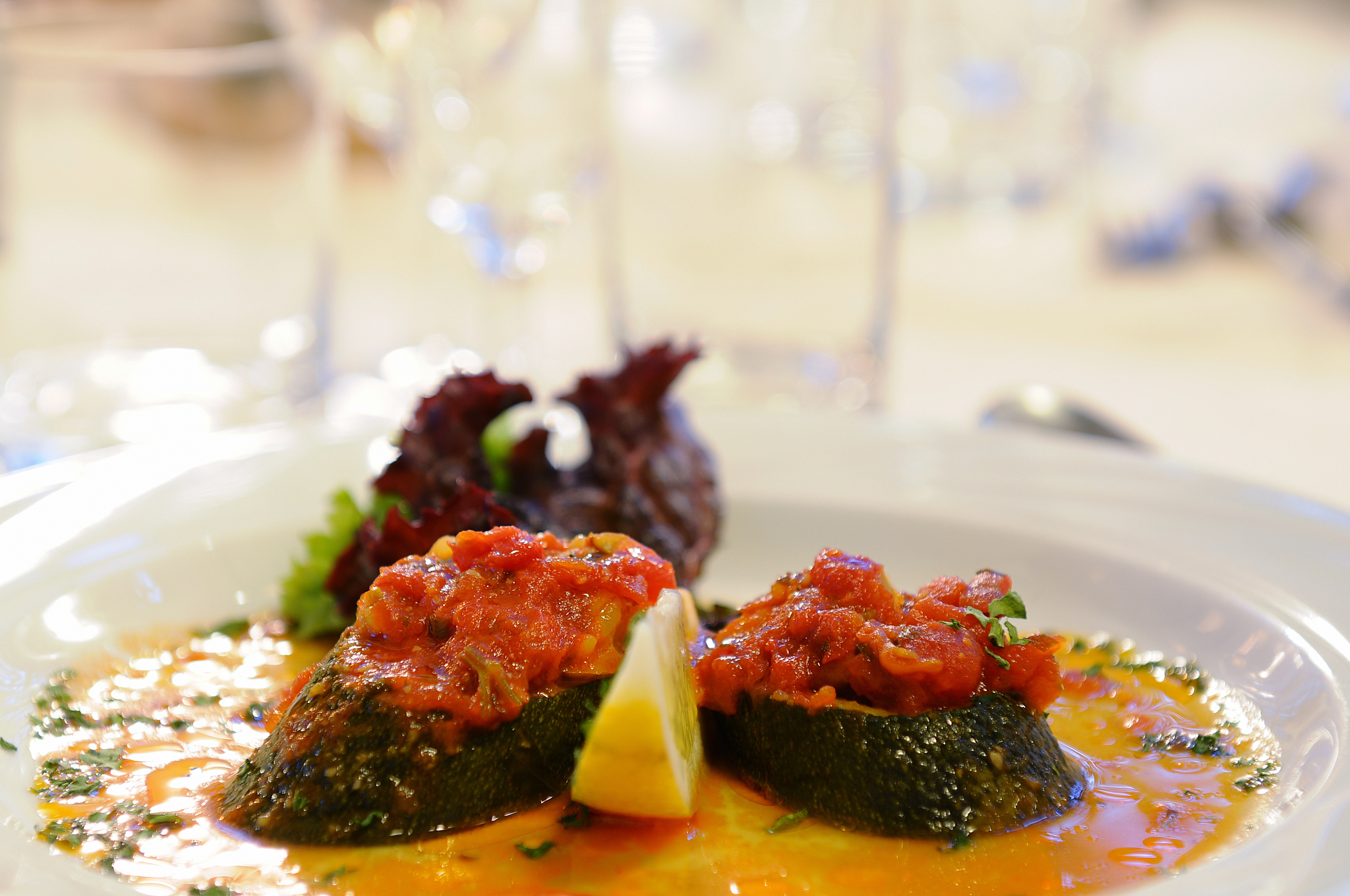 appetizer, zucchini with tomatoes in sauce on china