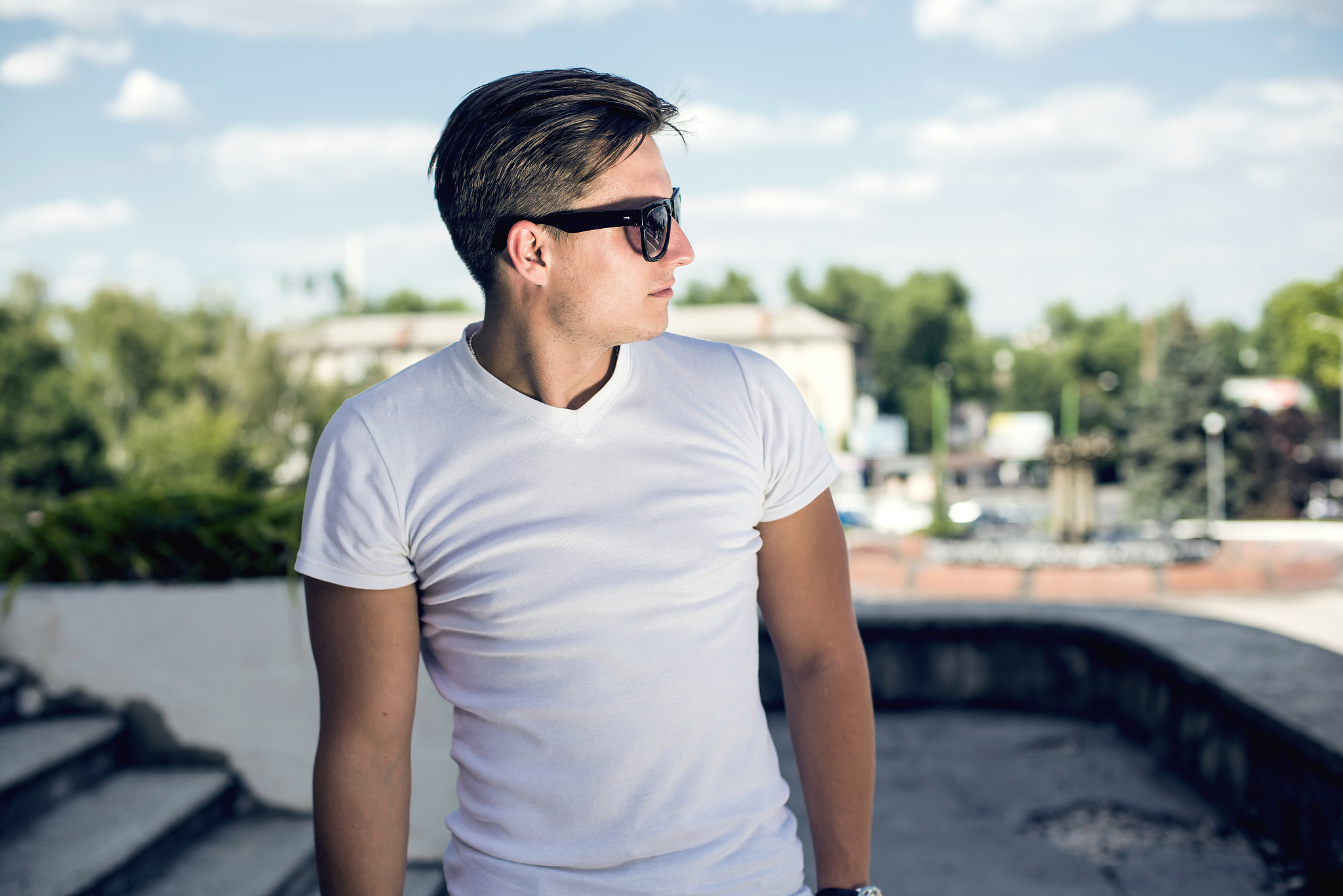 man in white shirt and dark eyeglasses on street