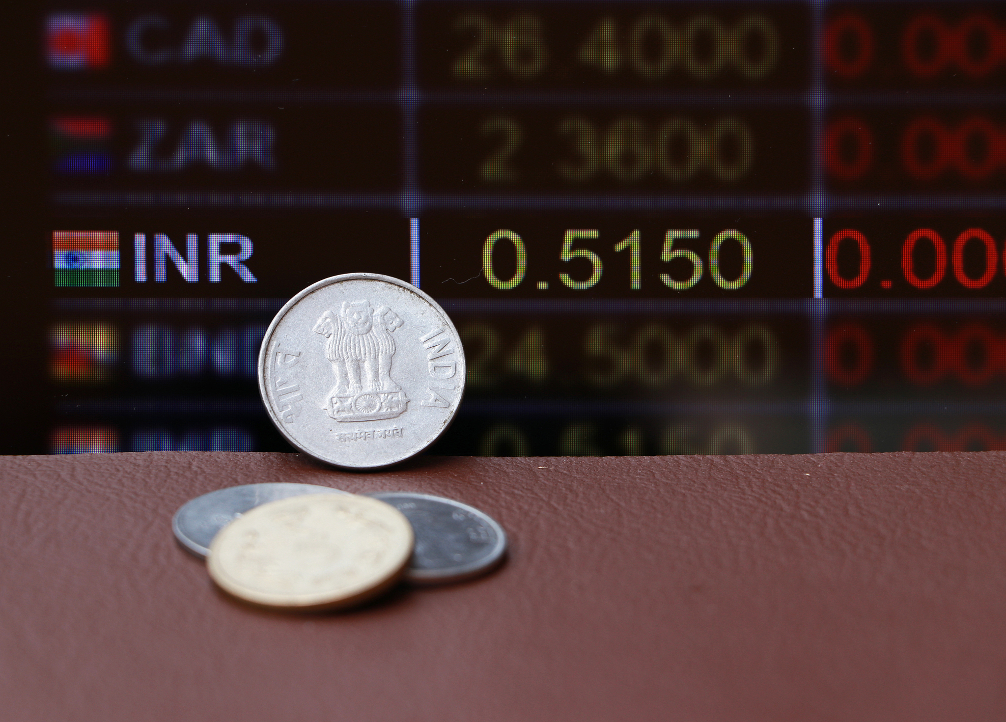 the coins of india rupee money on brown floor with digital board