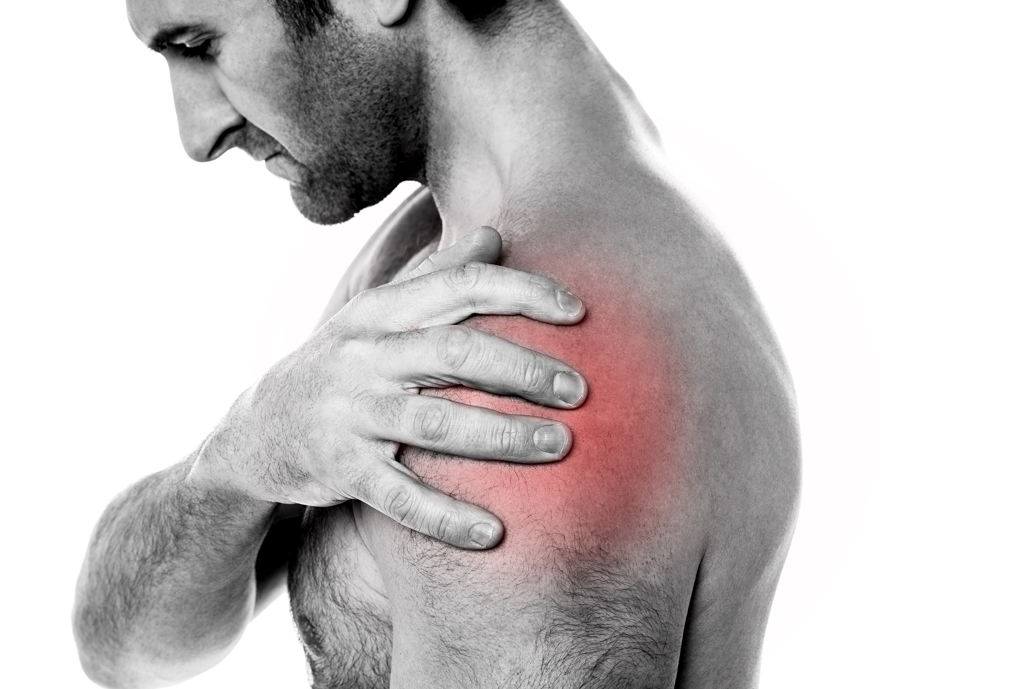 closeup of young man having pain in shoulder